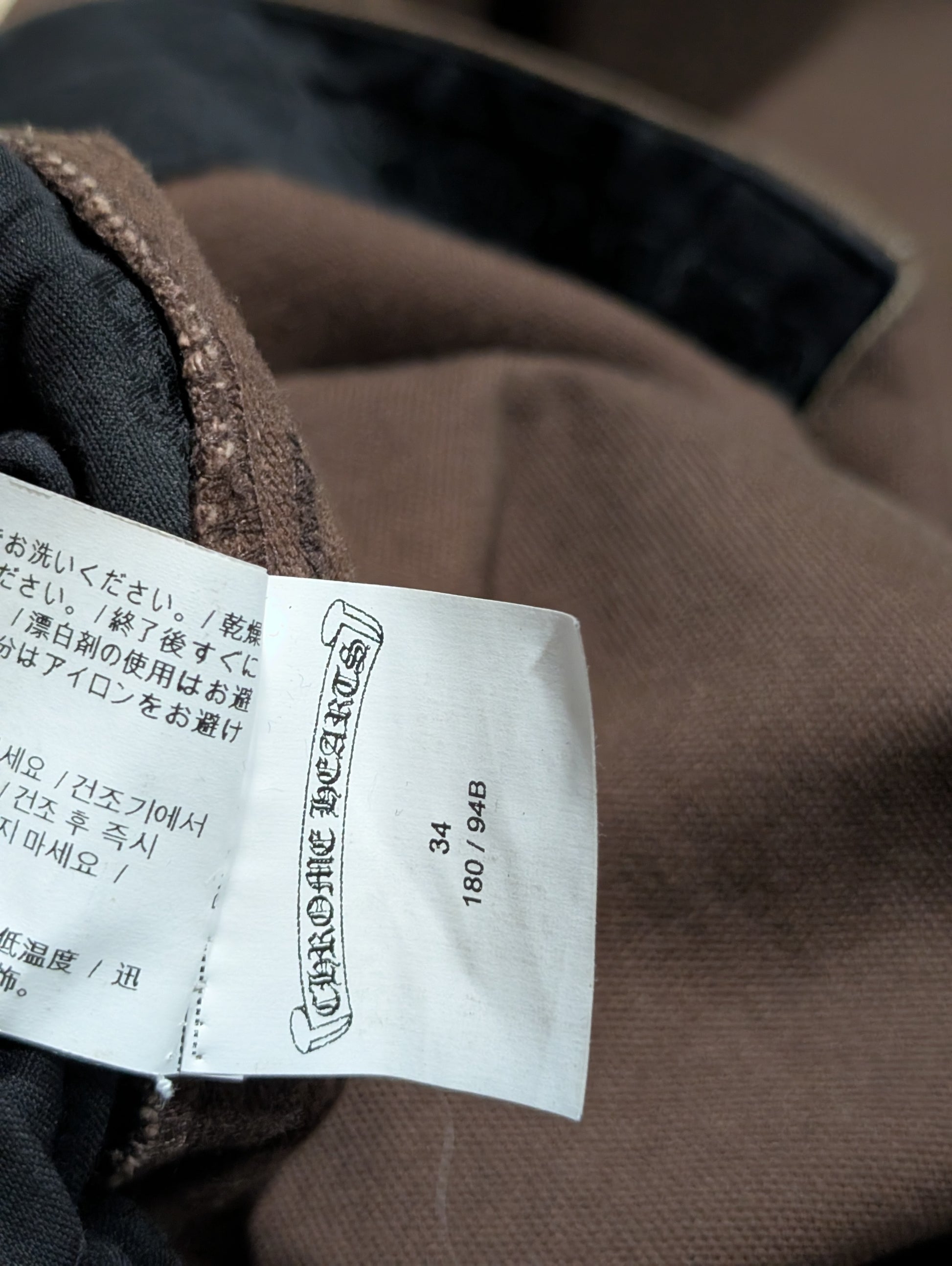 chrome hearts carpenter pants size tag close up brown double knee black leather cross patch