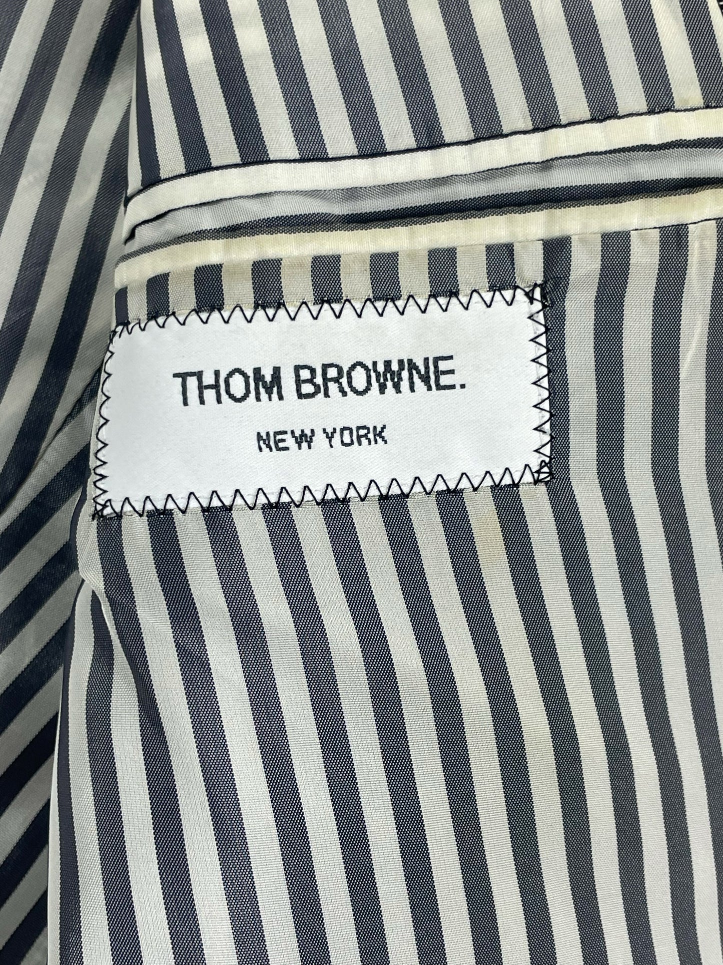 Prince of Wales check Thom Browne suit jacket with three-button cuffs