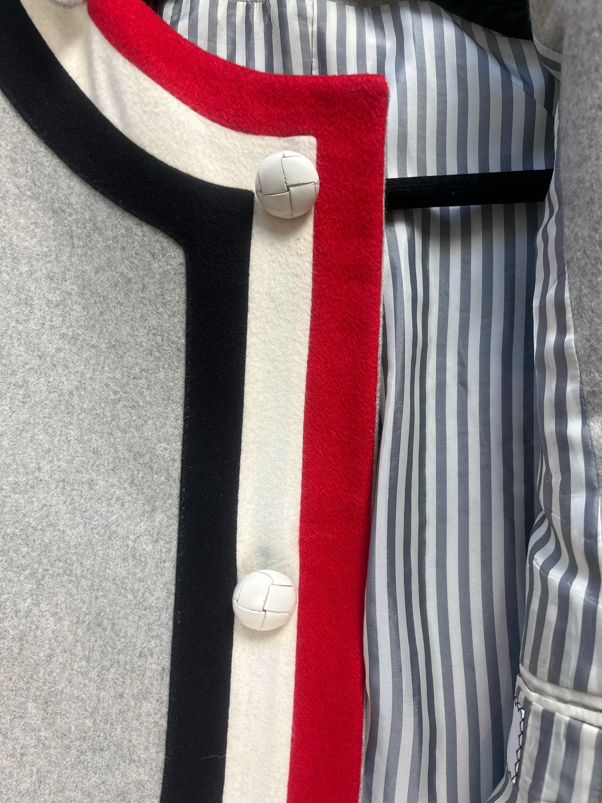 Red white blue grosgrain placket and leather ball buttons on Thom Browne cashmere coat