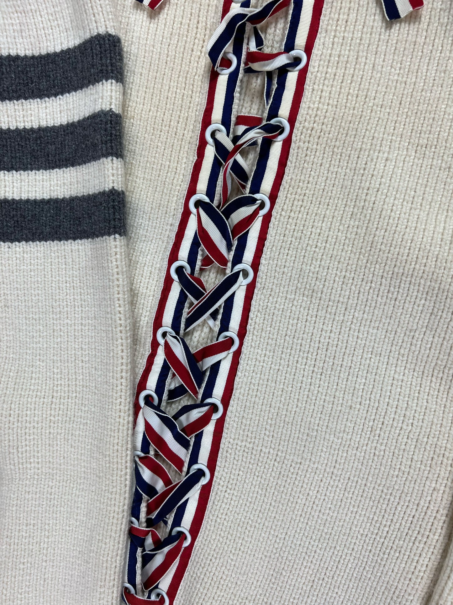 Red white blue grosgrain lace-up corset on Thom Browne cashmere sweater