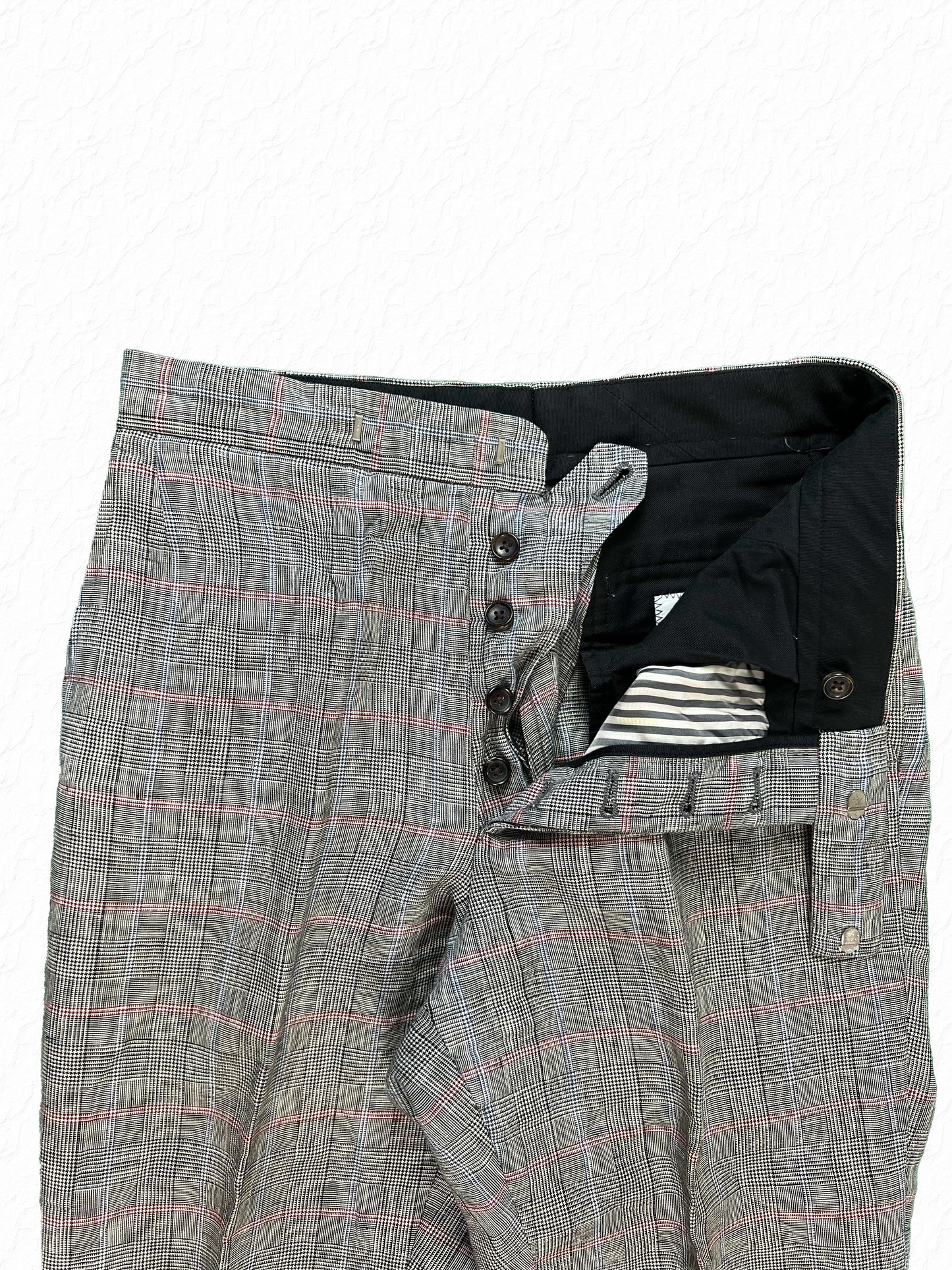 Grey Prince of Wales check trousers by Thom Browne with button fly closure