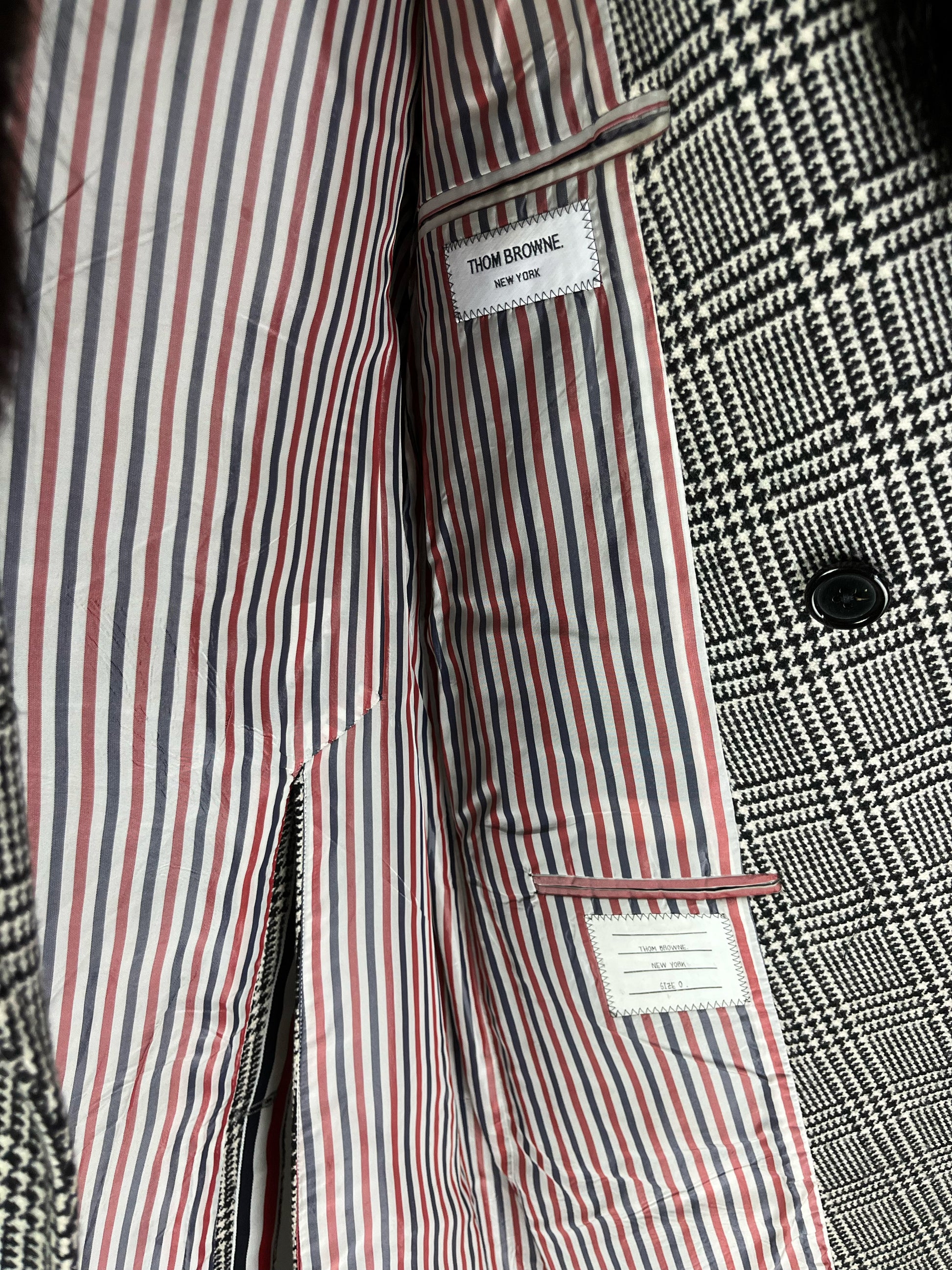 Glen plaid wool overcoat by Thom Browne with signature tricolor grosgrain trim