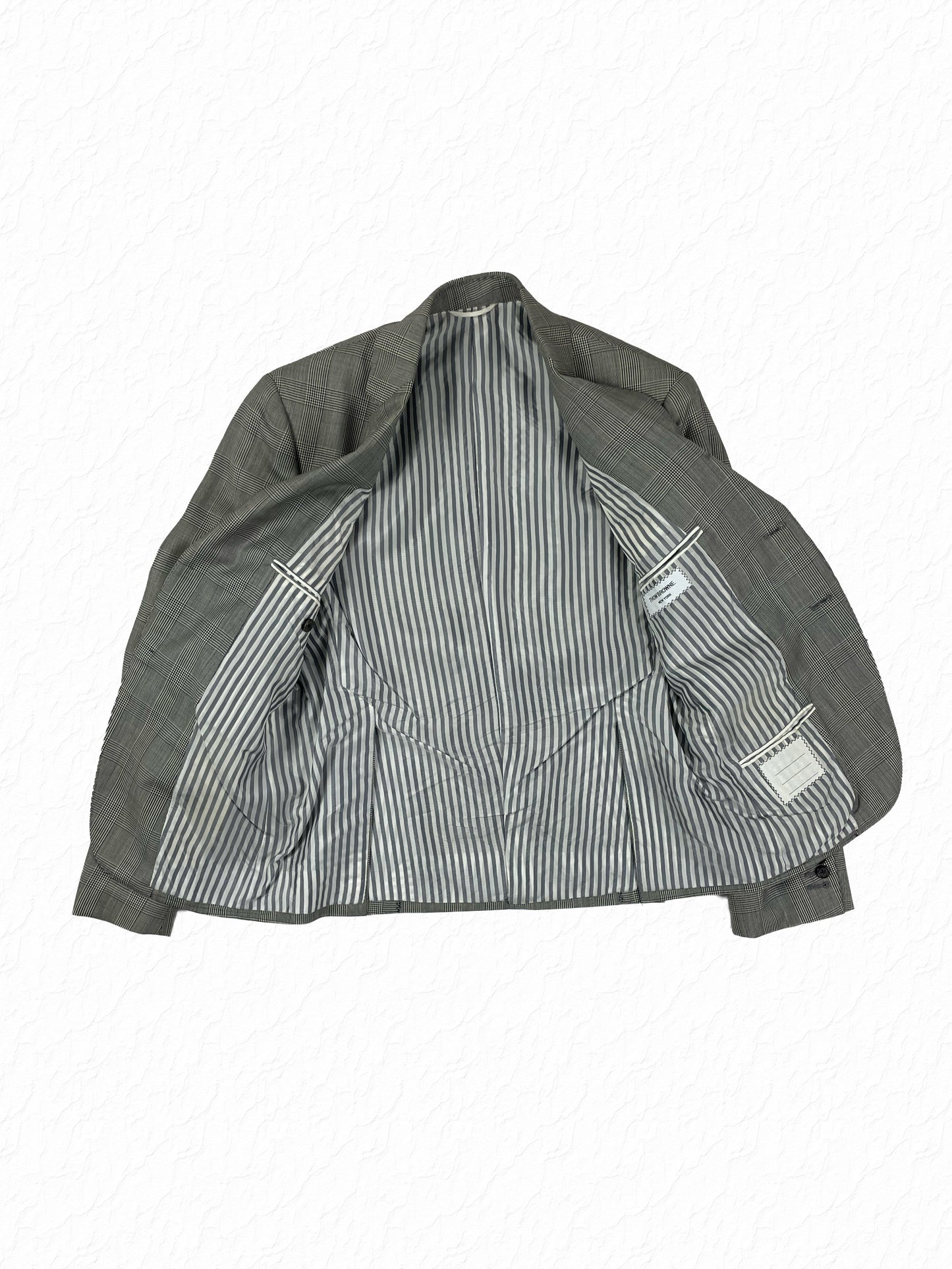 Grey striped lining interior of Thom Browne Boy Cut wool jacket