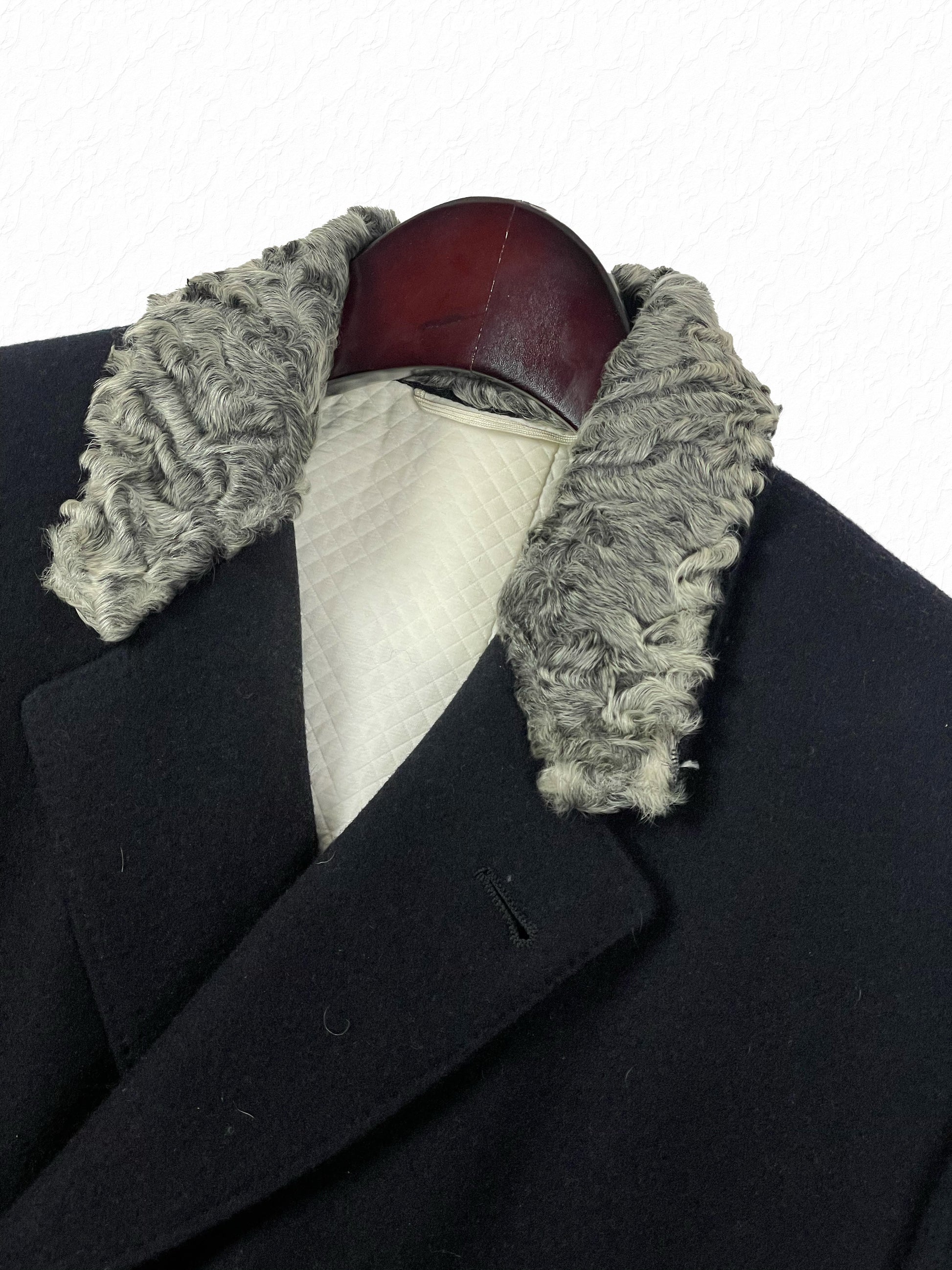 Grey astrakhan fur top collar on navy Thom Browne double breasted coat