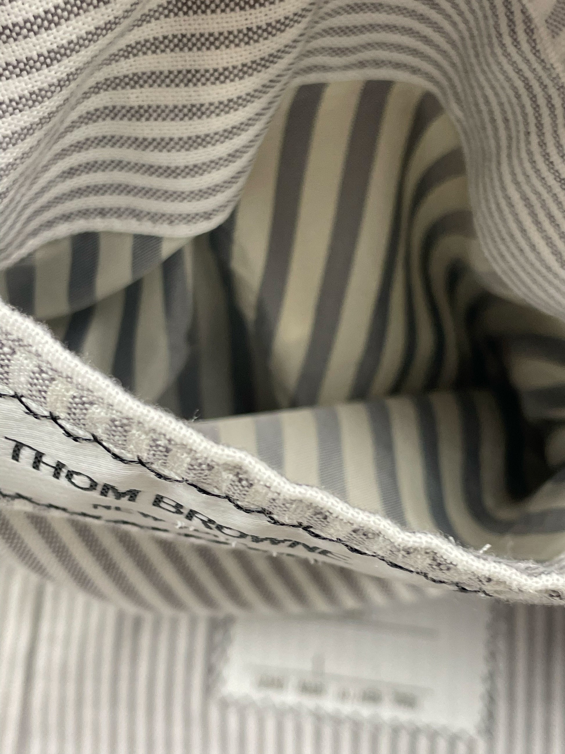 Grey and white striped cotton lining inside Thom Browne herringbone blazer
