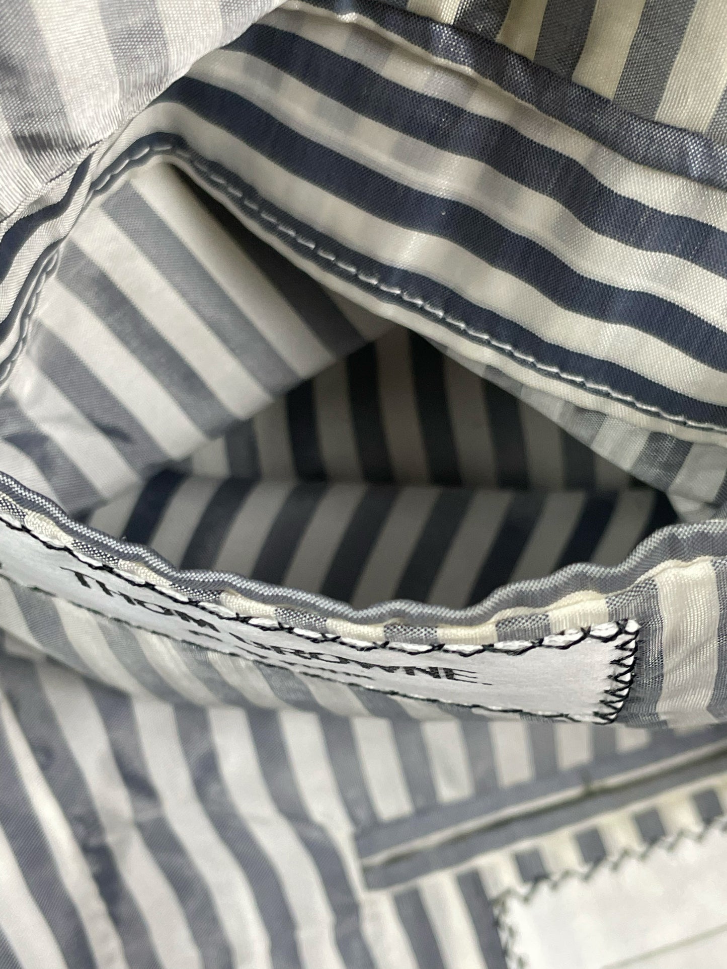 Signature red white blue grosgrain interior tab on Thom Browne wool blazer