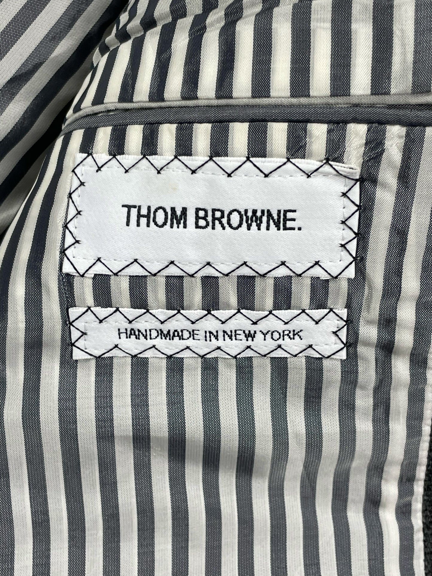 Thom Browne handmade New York woven brand label on grey wool blazer