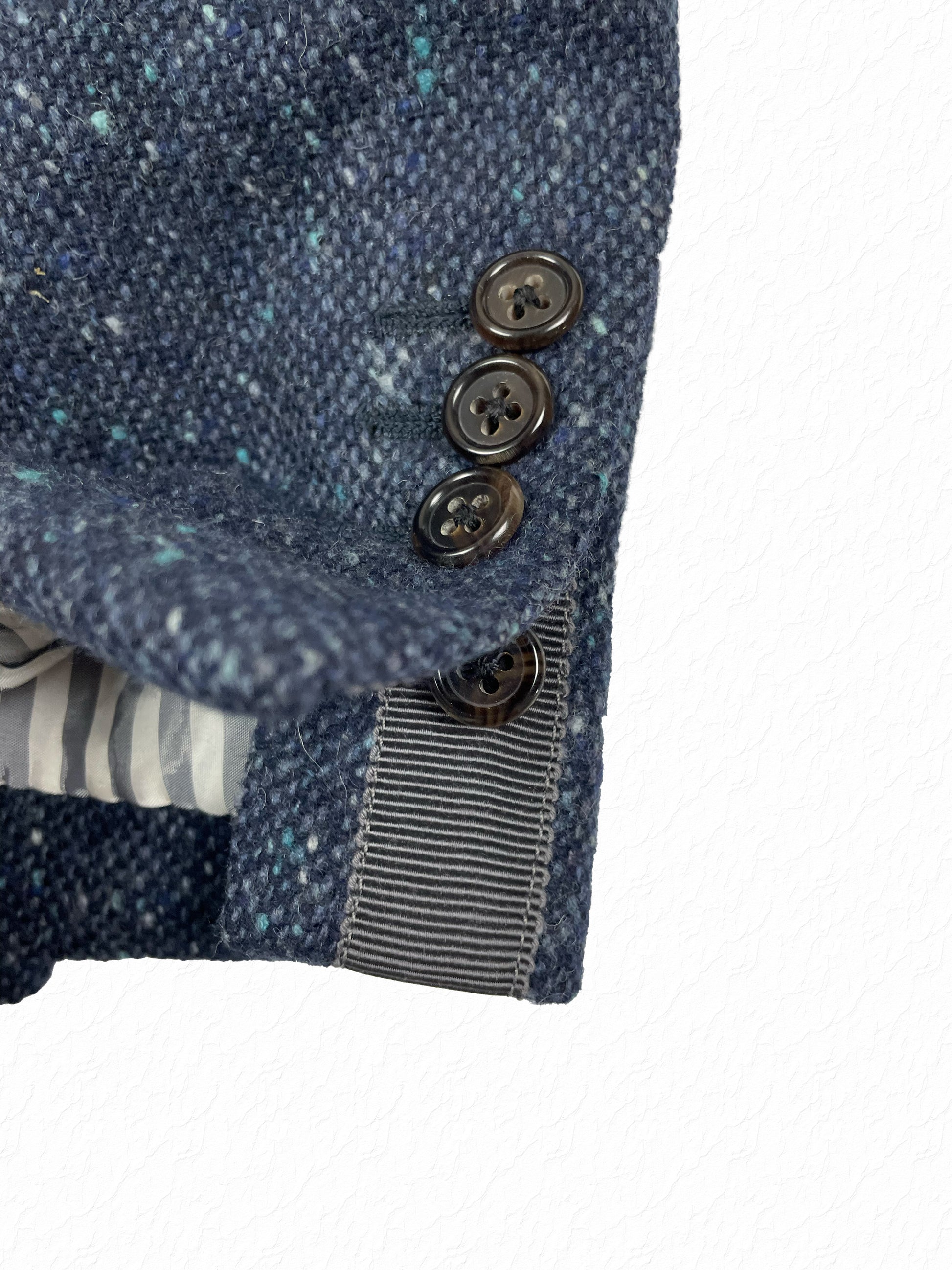 Pebble Donegal tweed texture with teal flecks on Thom Browne sport coat
