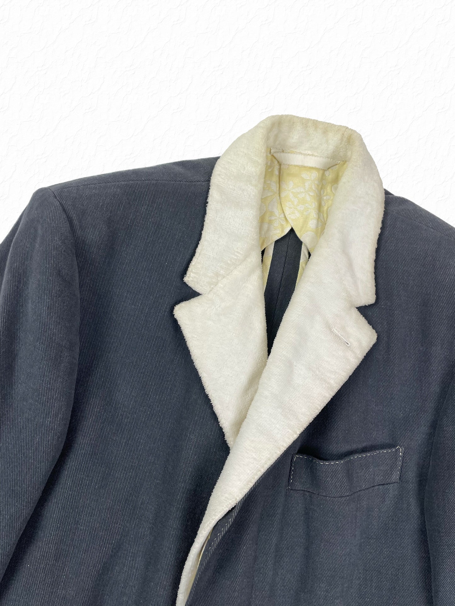 White toweling notch lapel on Thom Browne grey Chesterfield overcoat