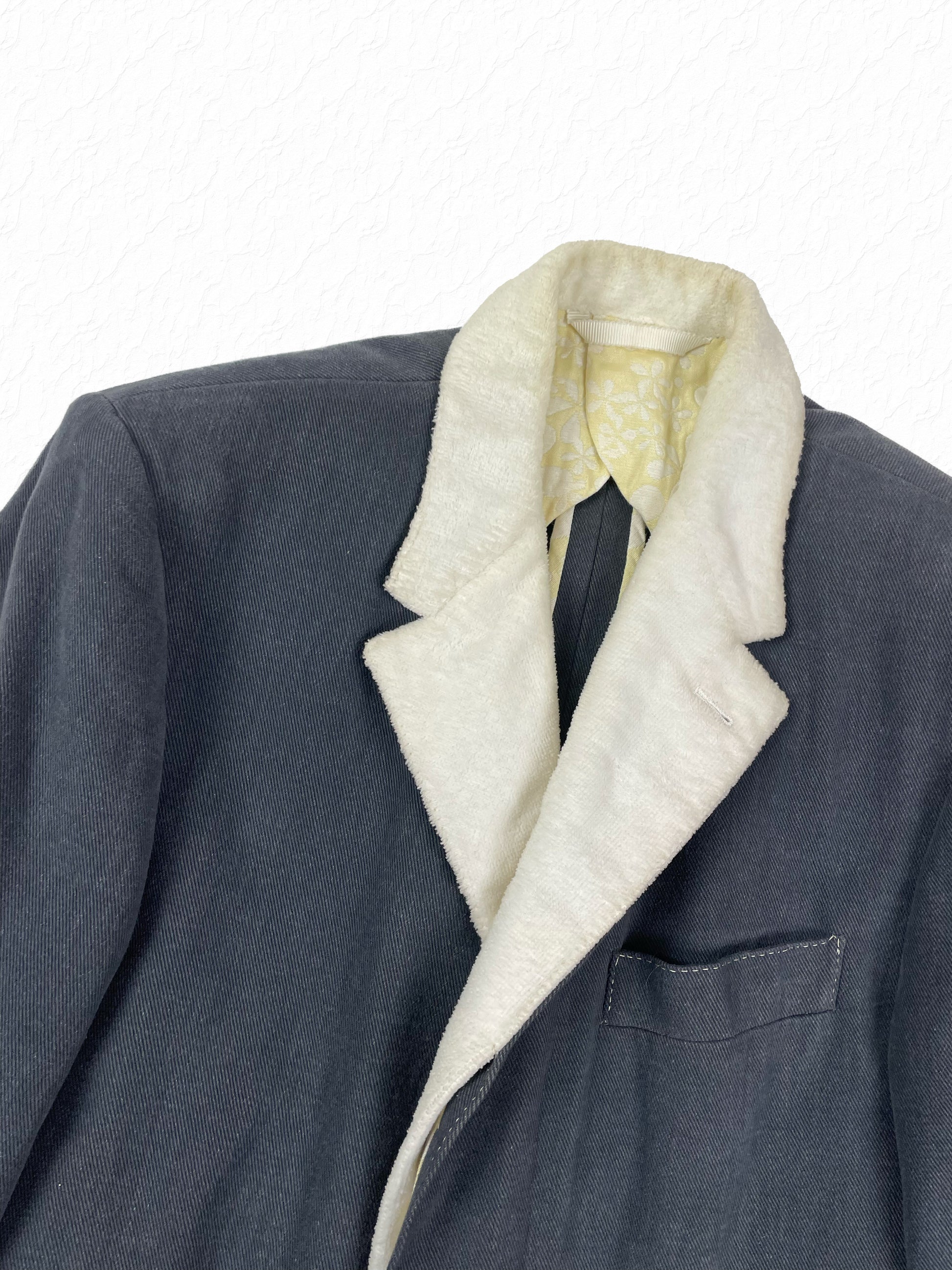 White toweling notch lapel on Thom Browne grey Chesterfield overcoat