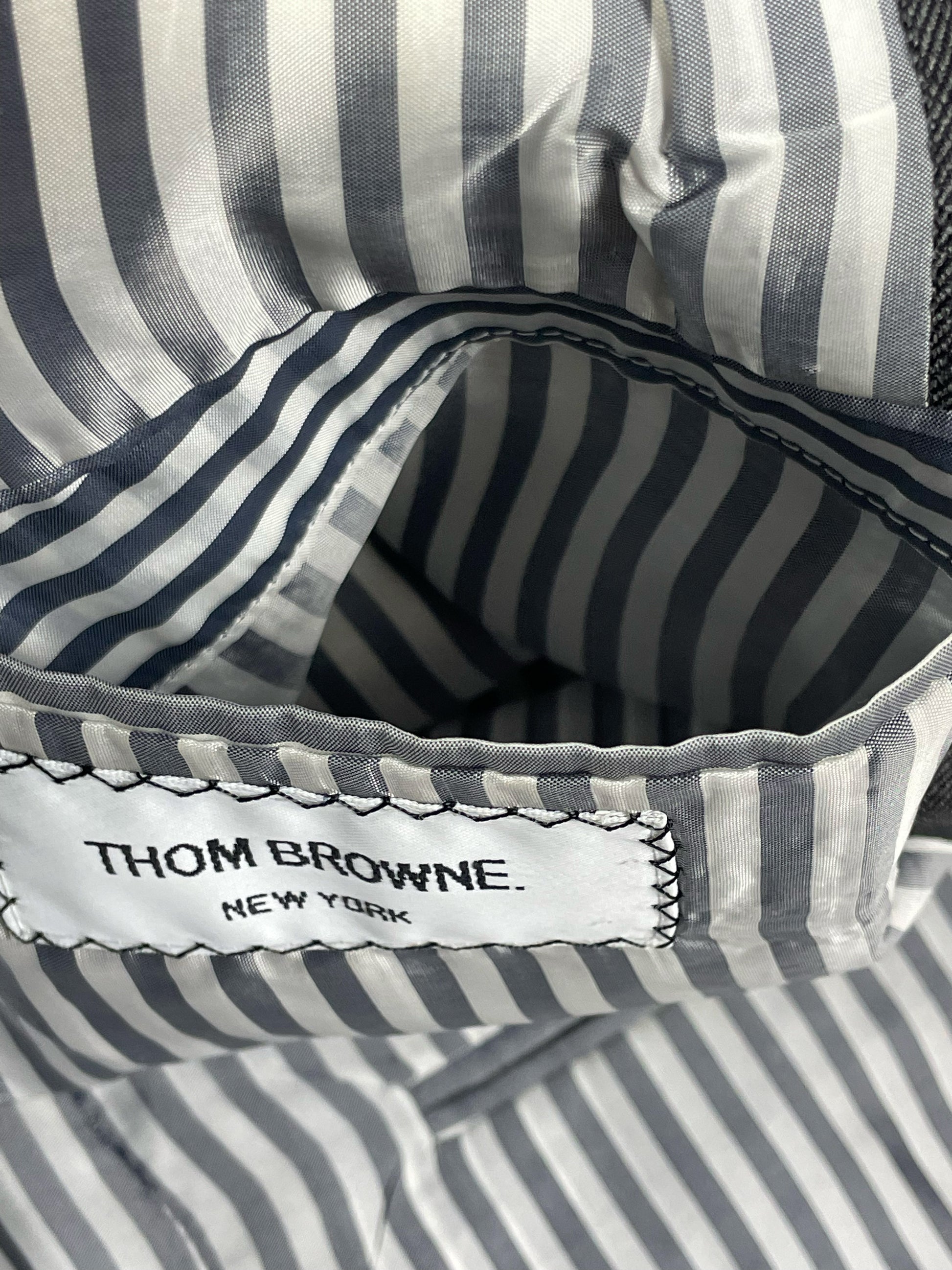 Grey striped interior lining on Thom Browne herringbone blazer
