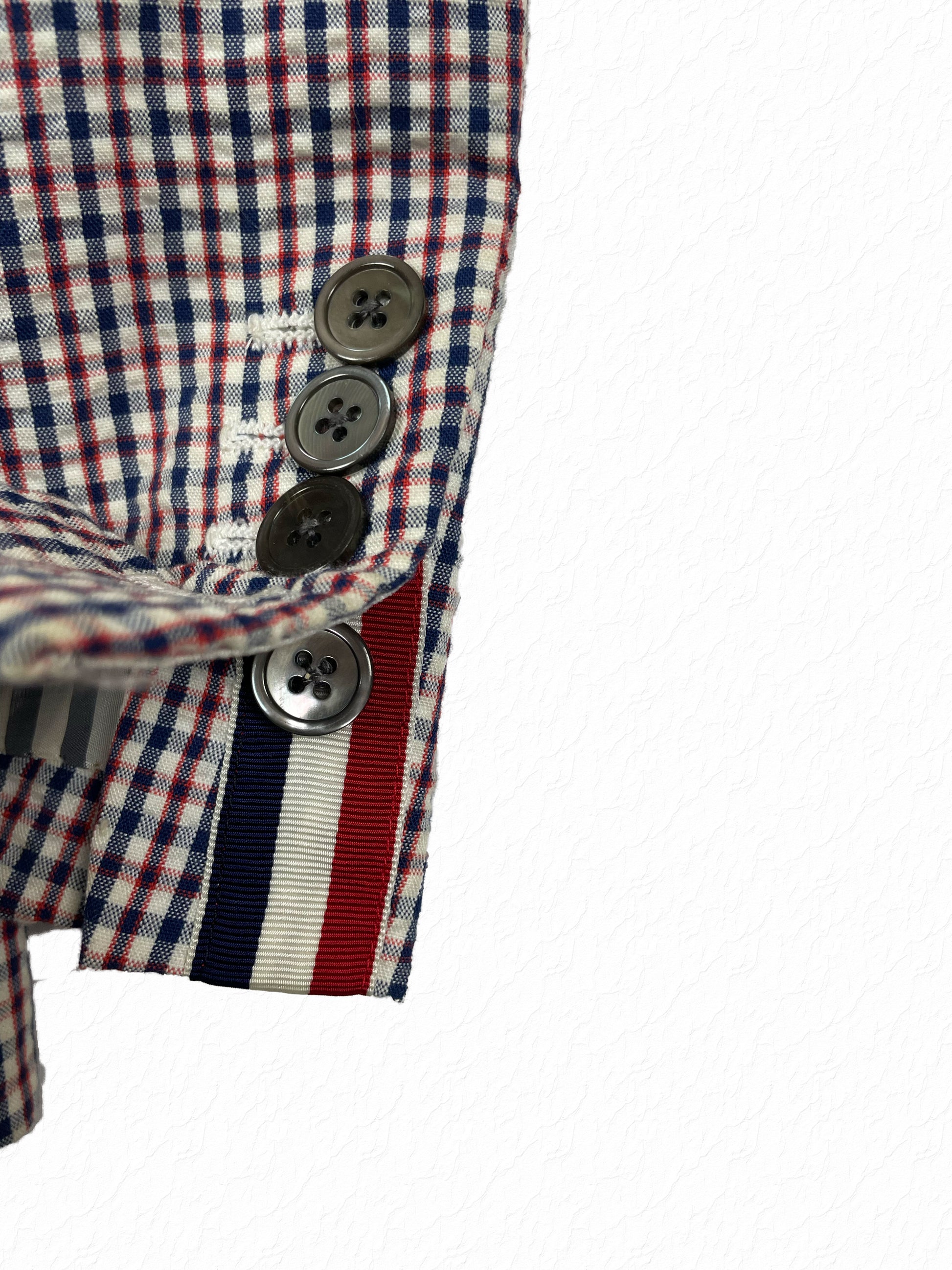 Grosgrain red white blue tricolor tab on Thom Browne gingham sport coat cuff