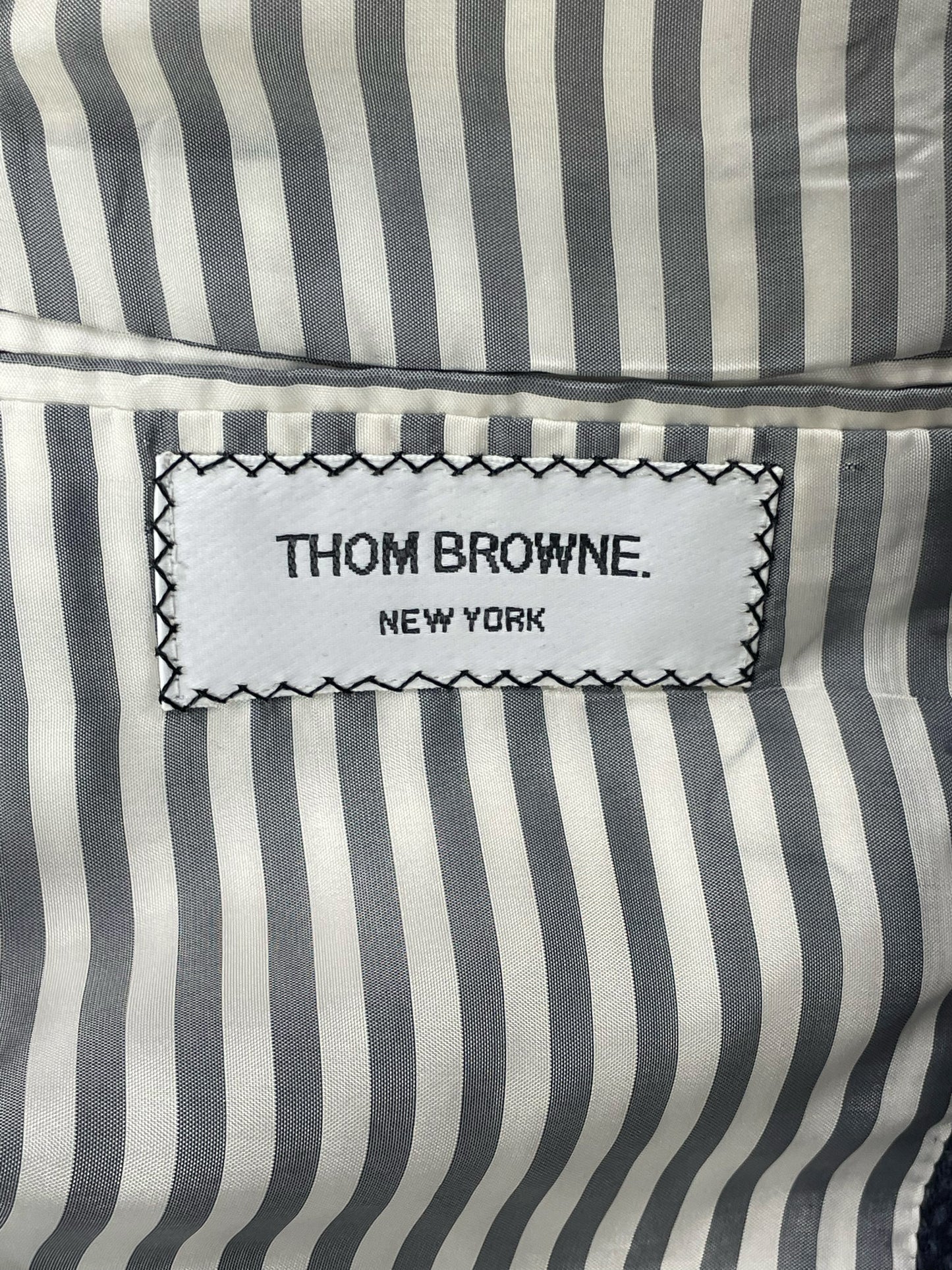 Thom Browne New York striped lining inside navy Donegal tweed jacket
