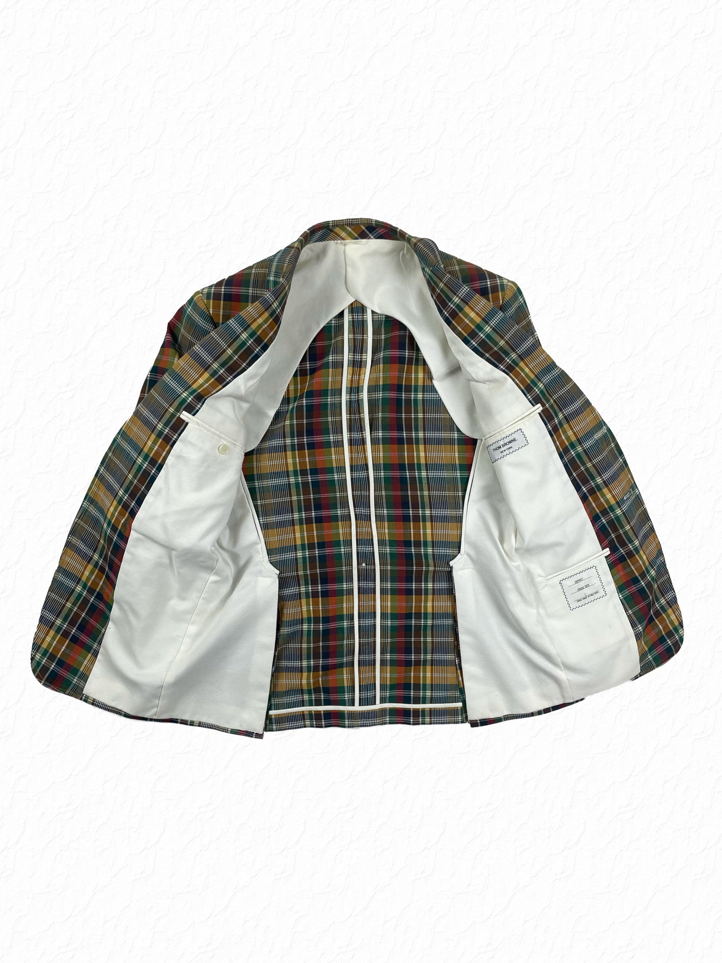 White Marcella cotton lining on Thom Browne madras plaid suit jacket