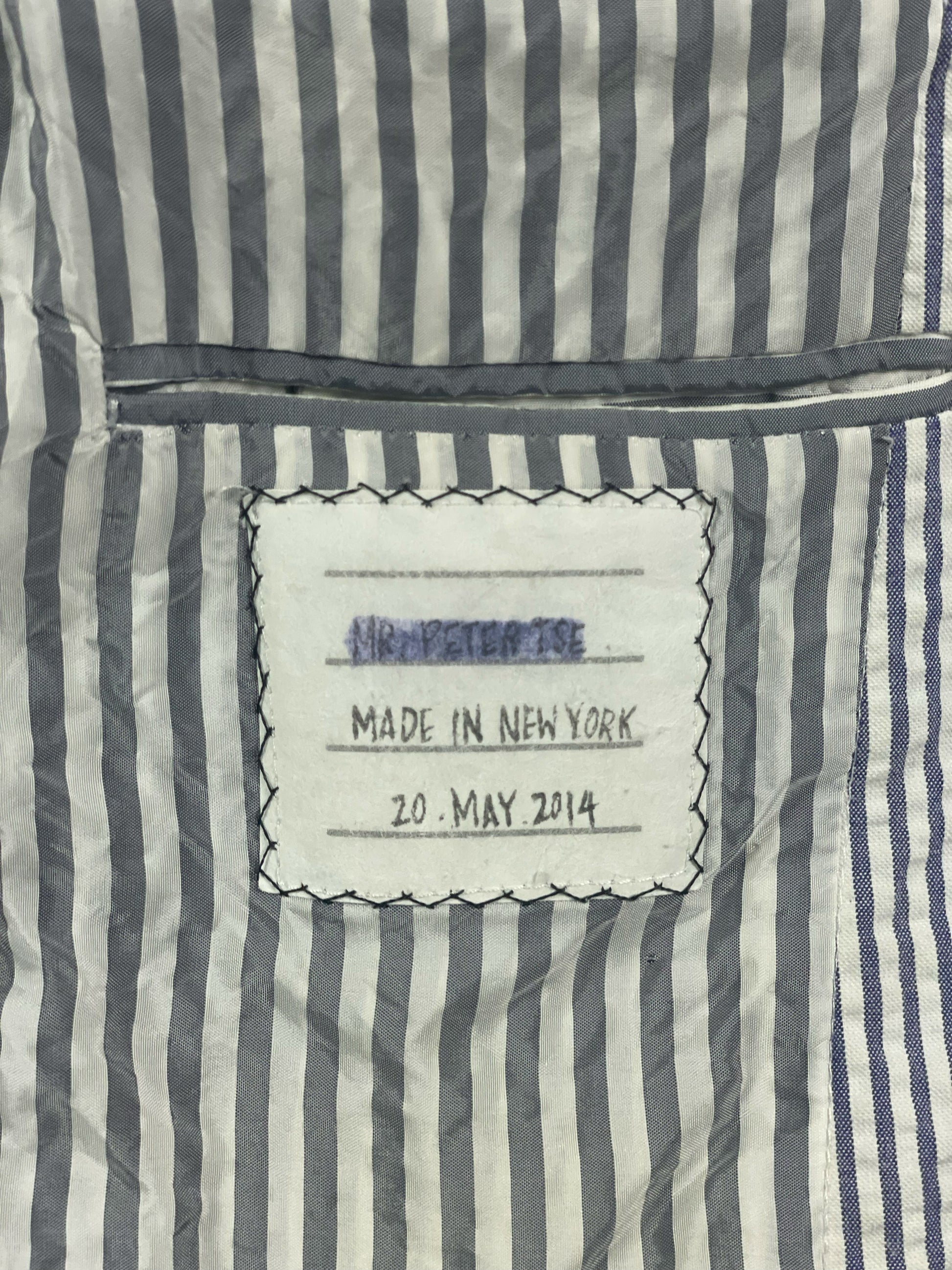 Grosgrain trimmed cuff buttons on archival Thom Browne seersucker jacket