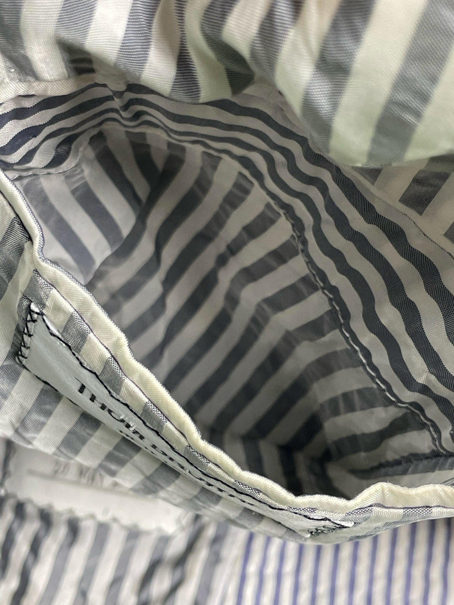 Signature Thom Browne New York label inside striped seersucker blazer