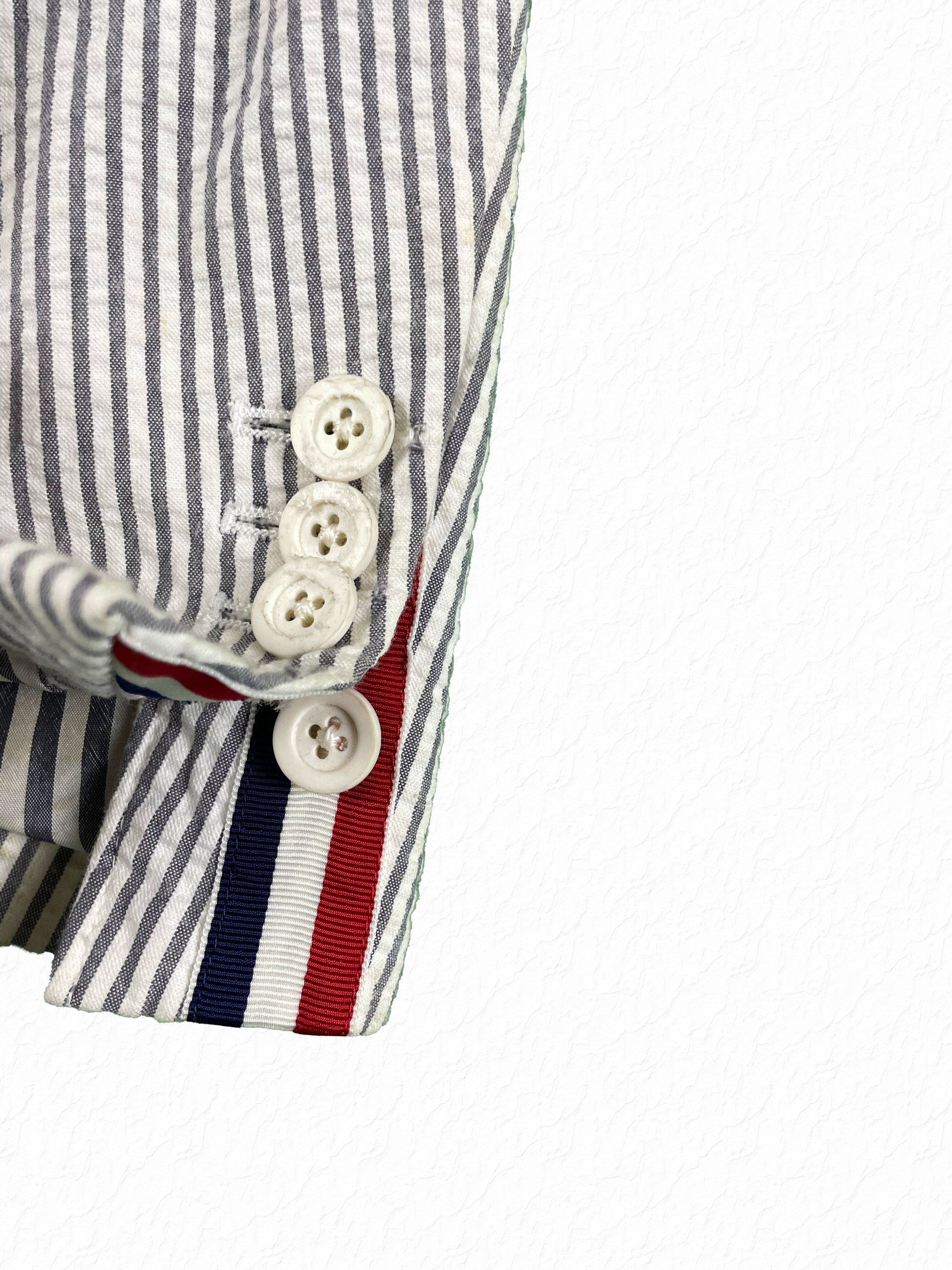 Thom Browne red white blue grosgrain tab with white rubber cuff buttons