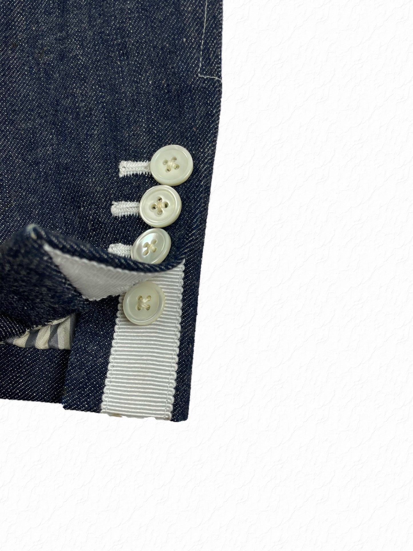 Four-button mother of pearl cuffs on Thom Browne Japanese denim blazer