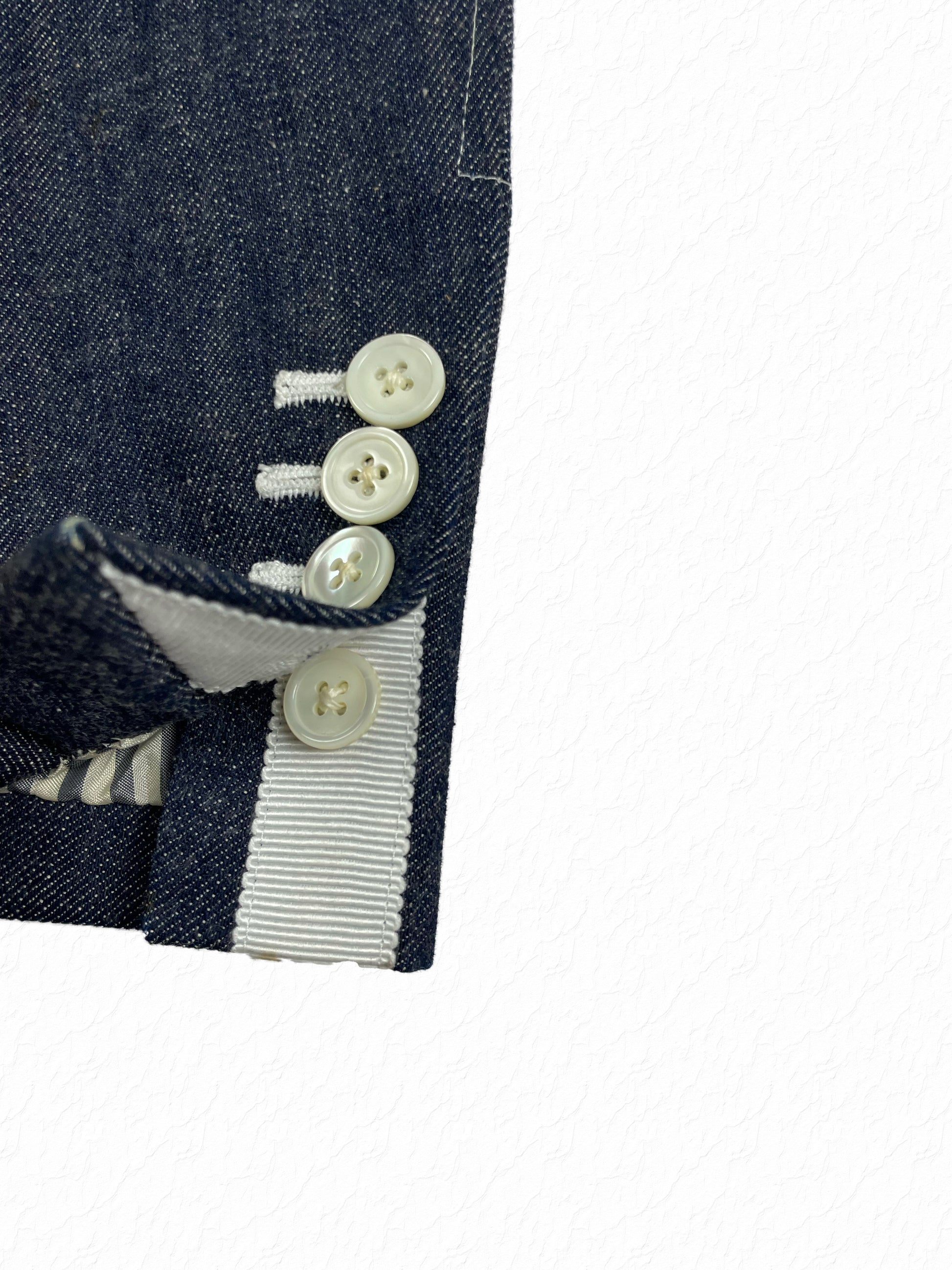 Four-button mother of pearl cuffs on Thom Browne Japanese denim blazer