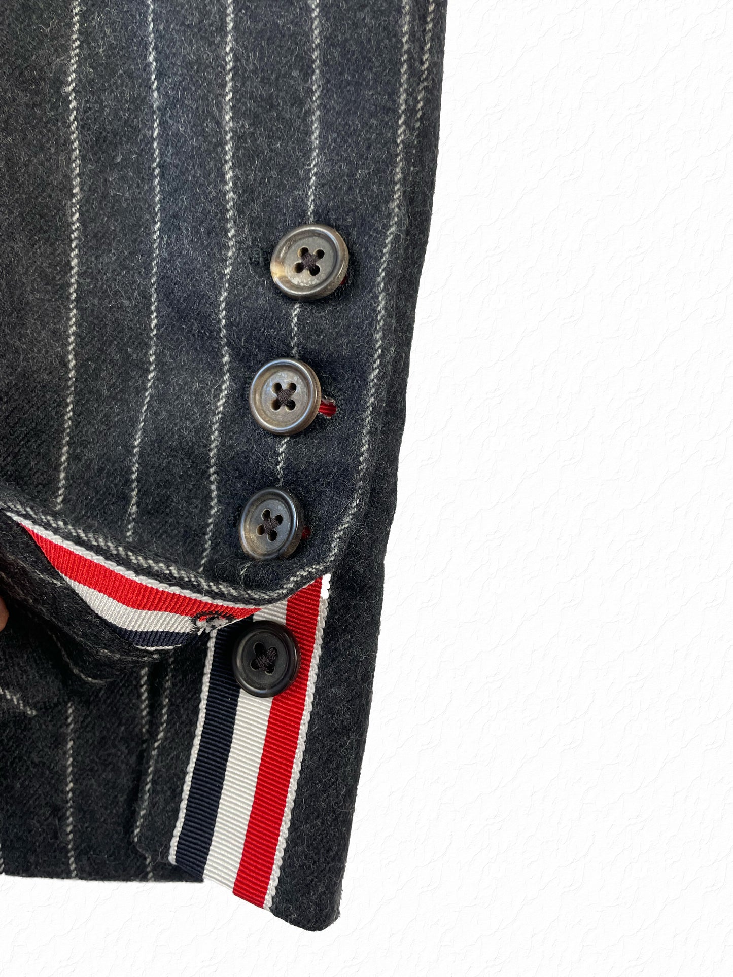 Grey pinstripe wool trousers with ankle button fly by Thom Browne