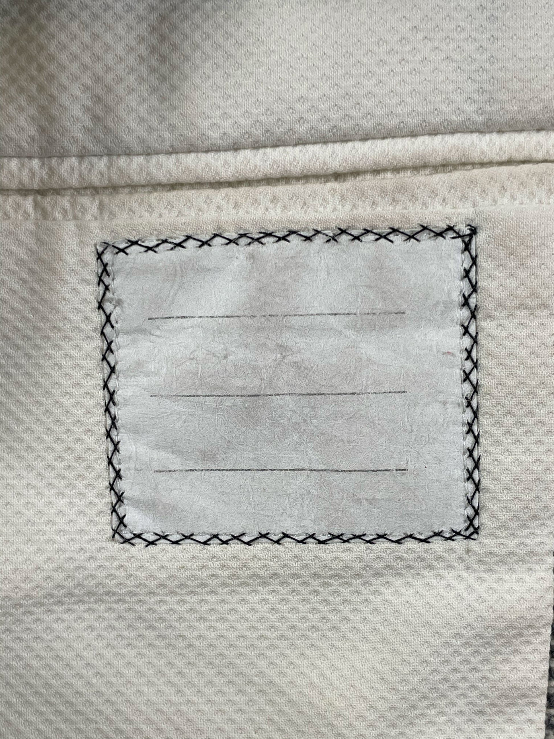 Cream interior lining of Thom Browne Fall 2005 tweed jacket