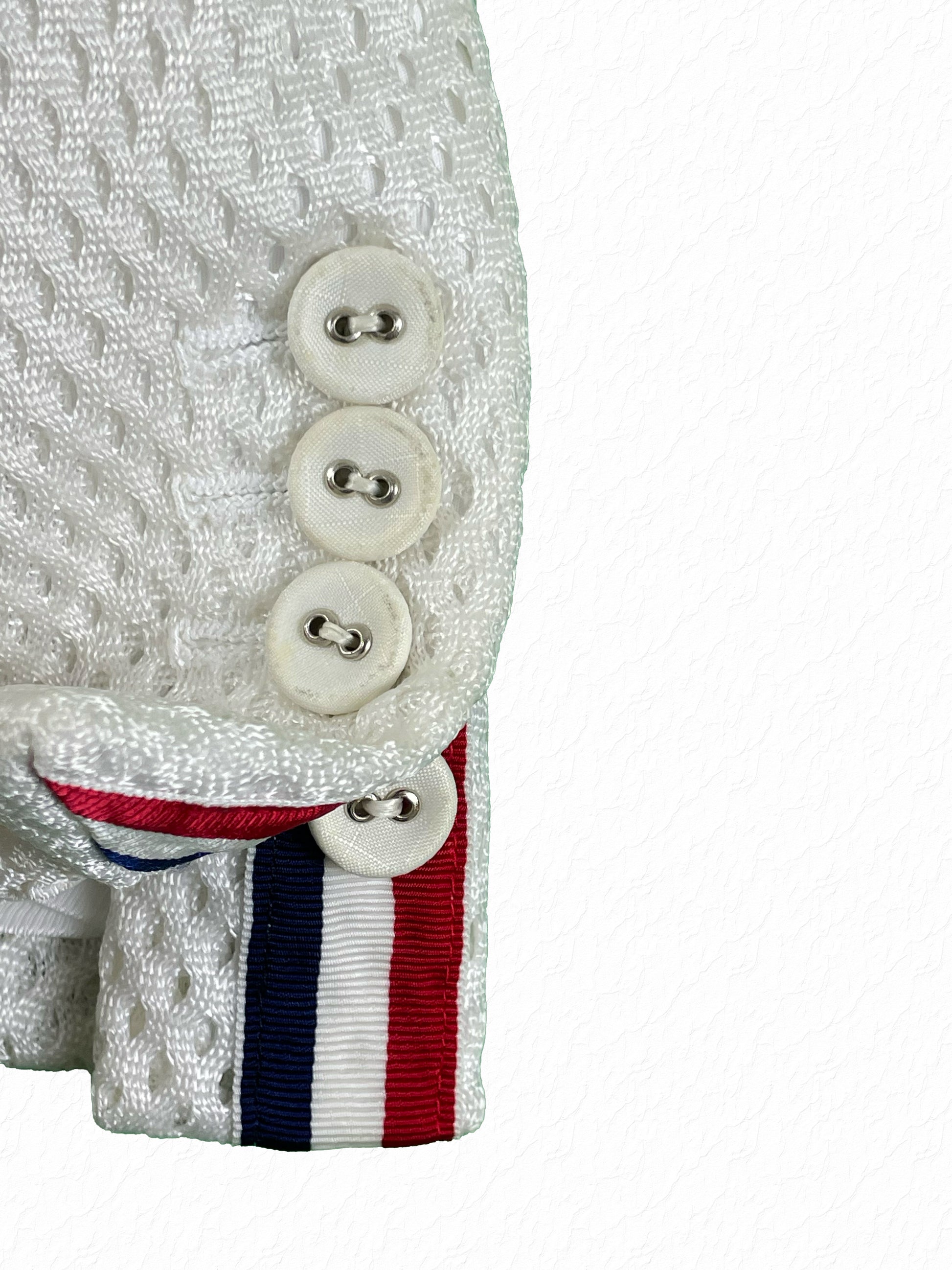 Red white blue grosgrain tab and cuff buttons on Thom Browne mesh jacket