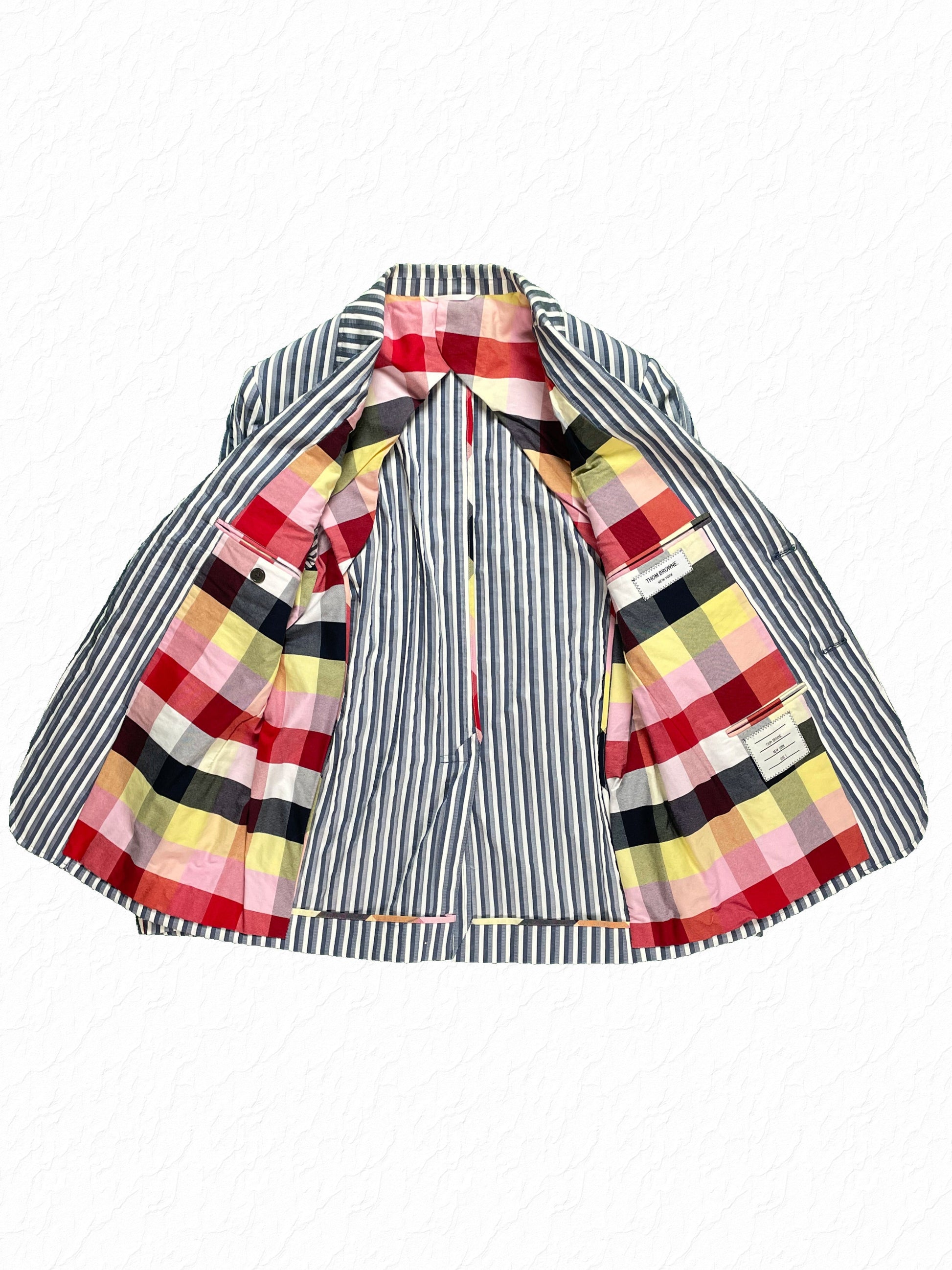 Multicolor madras check cotton lining on Thom Browne striped nylon jacket