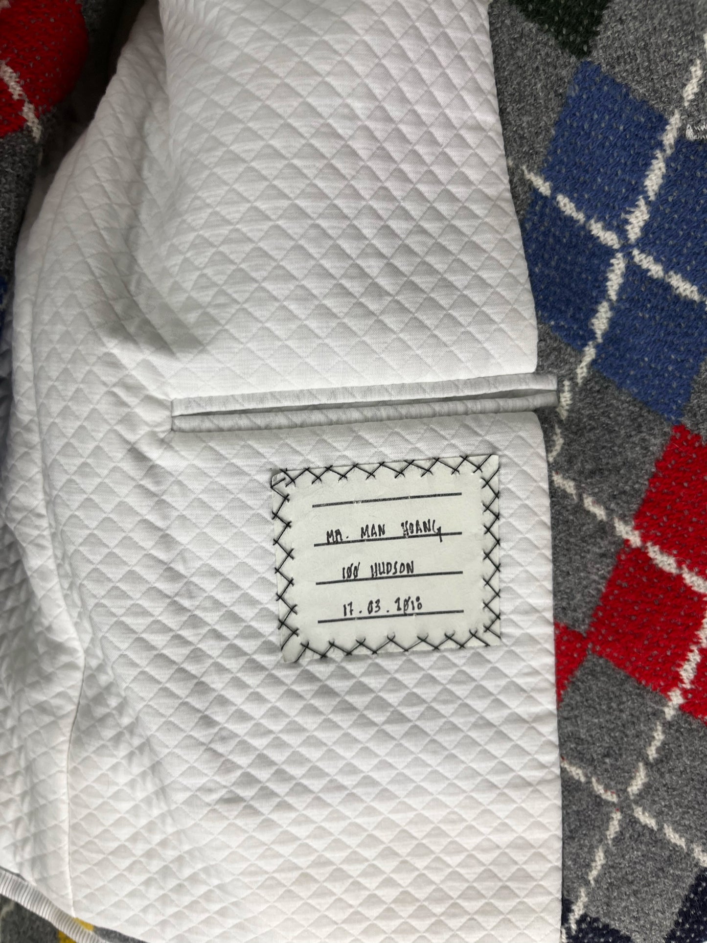 White quilted interior lining of Thom Browne bespoke argyle cashmere jacket