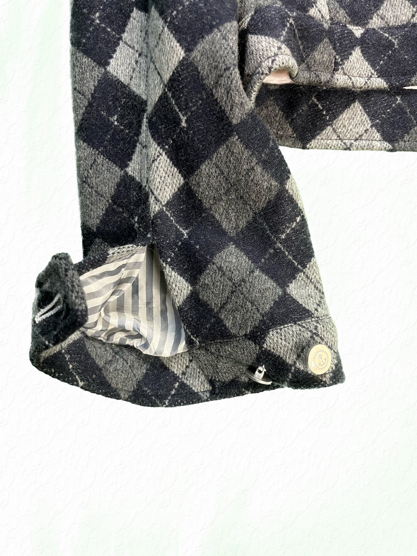 Snap cuff on Thom Browne argyle cashmere jacket with striped lining