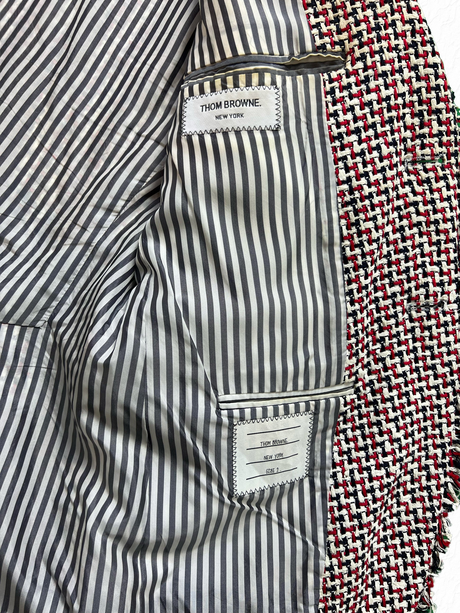Frayed tufted seams on Thom Browne RWB rubber tweed jacket