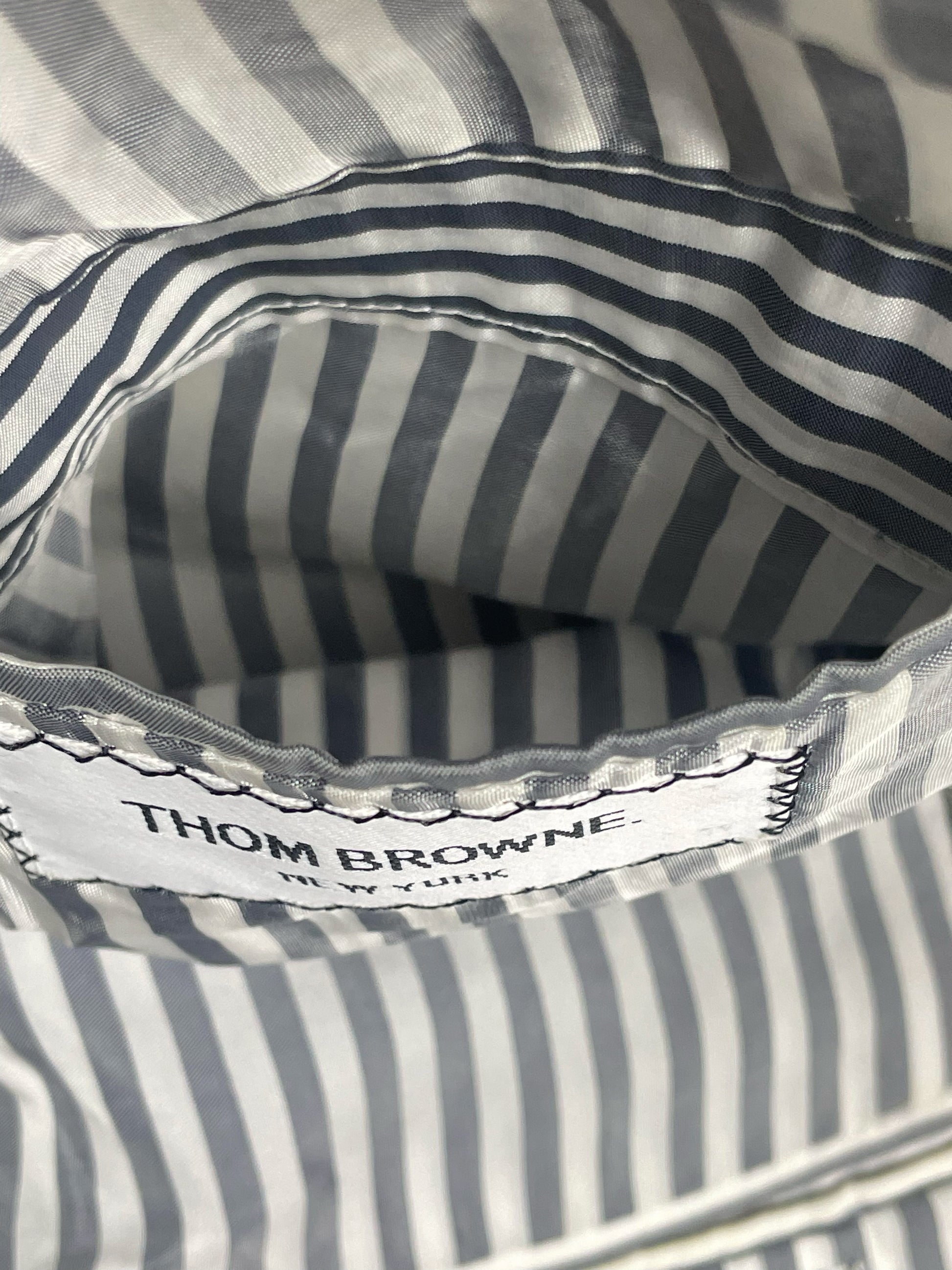 Thom Browne New York woven brand label on grey ropestripe blazer