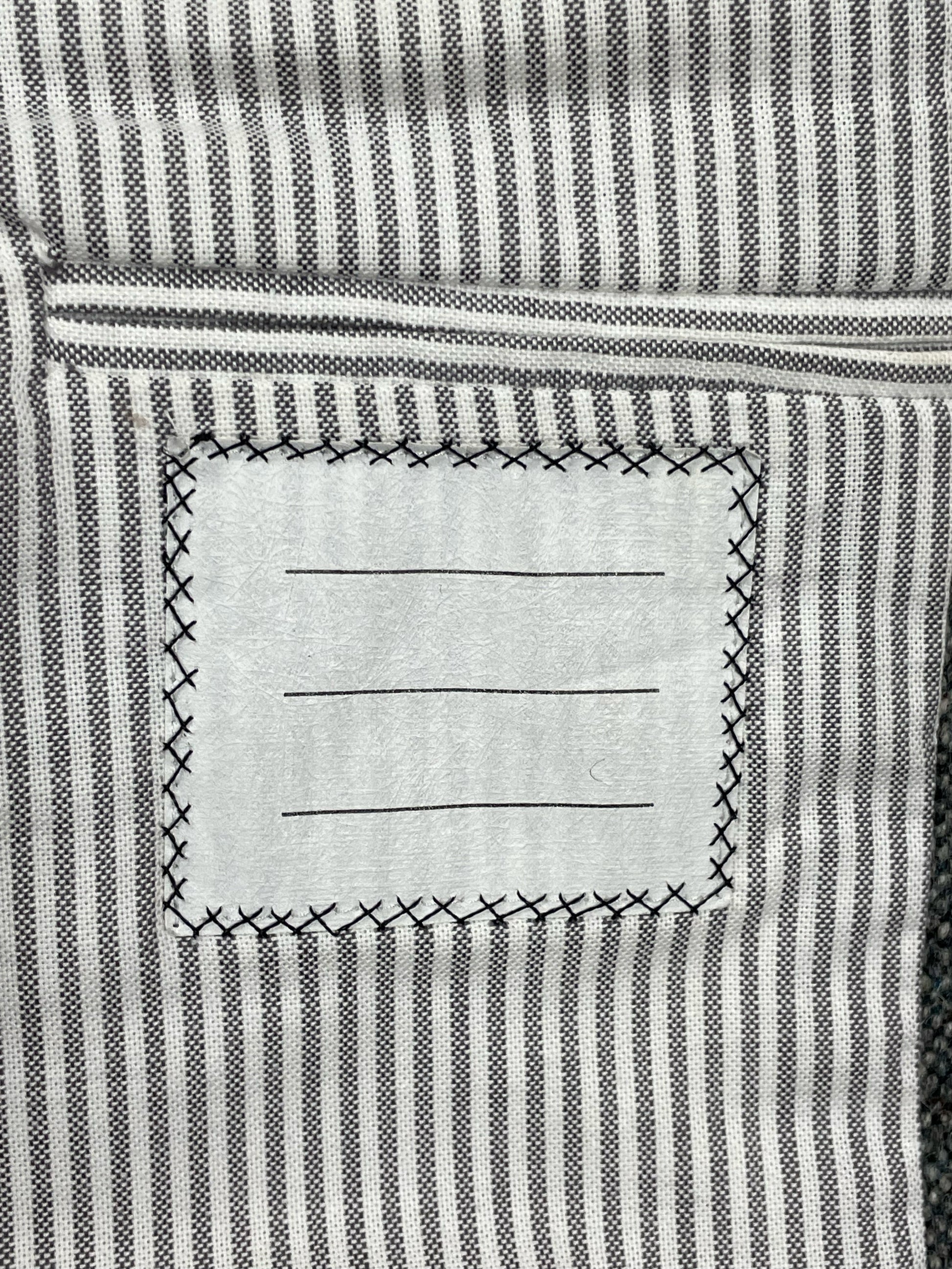 Striped cotton lining inside Thom Browne grey tweed blazer