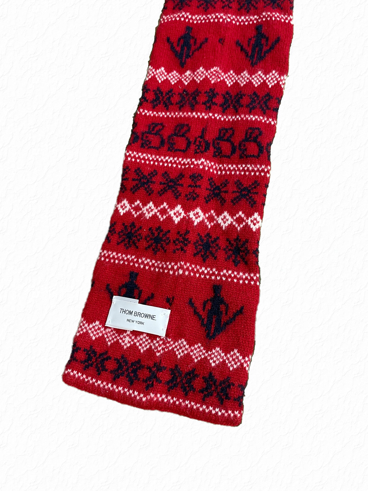 Red Fair Isle knit scarf by Thom Browne with navy snowflake and diamond patterning