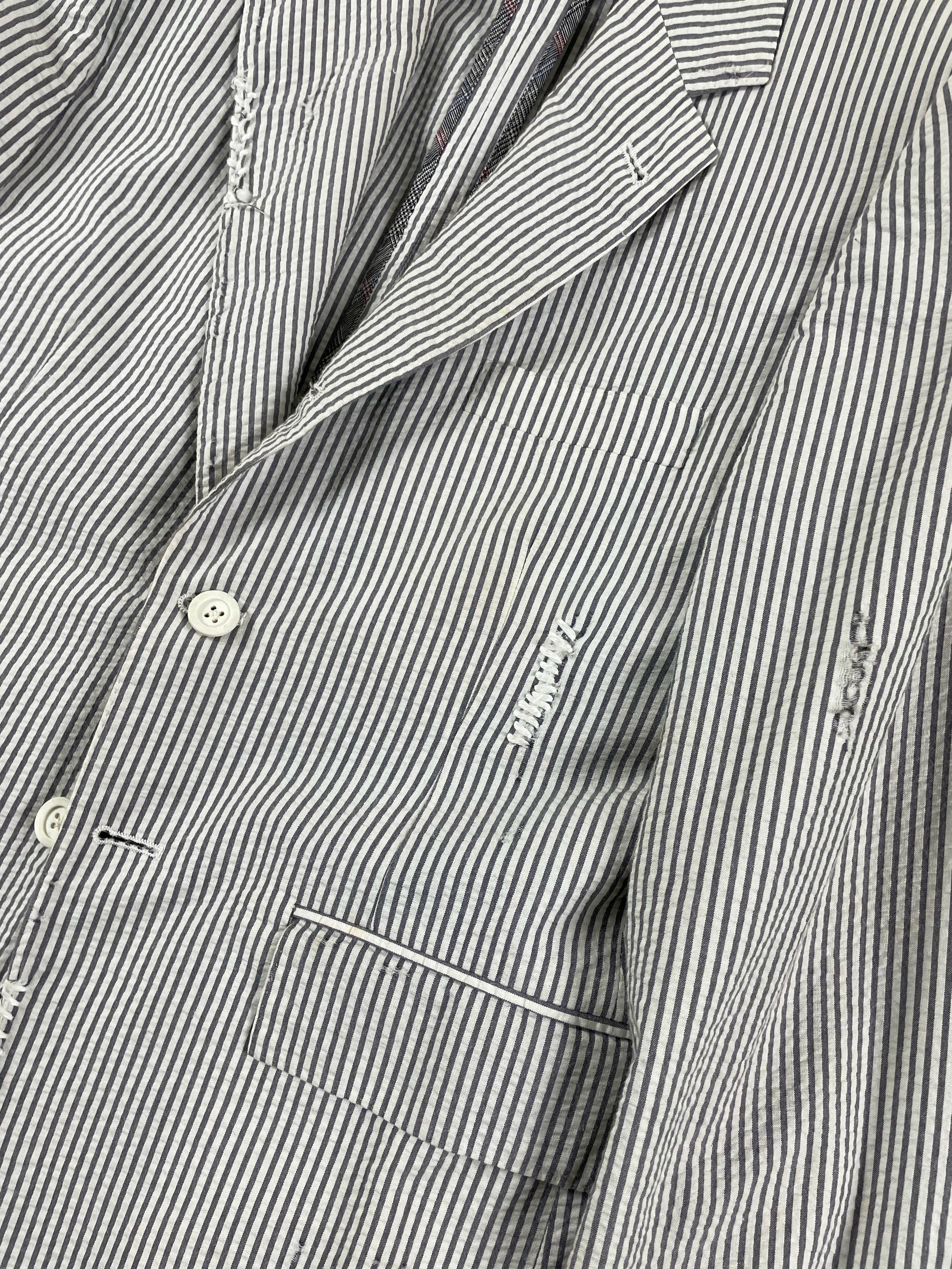 Distressed seersucker Thom Browne blazer with notch lapel and frayed edges