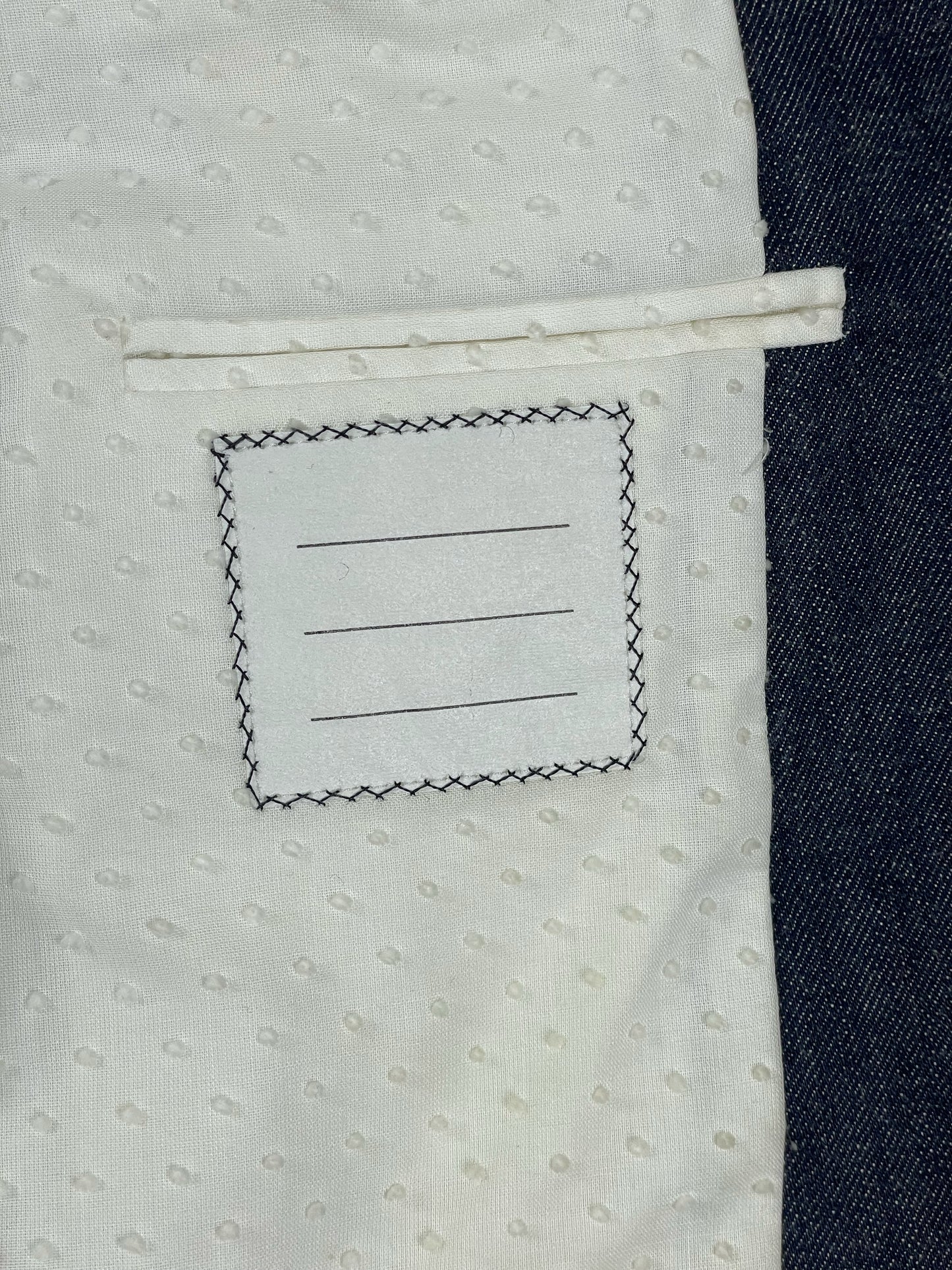 Thom Browne New York interior spec label on indigo Japanese denim jacket