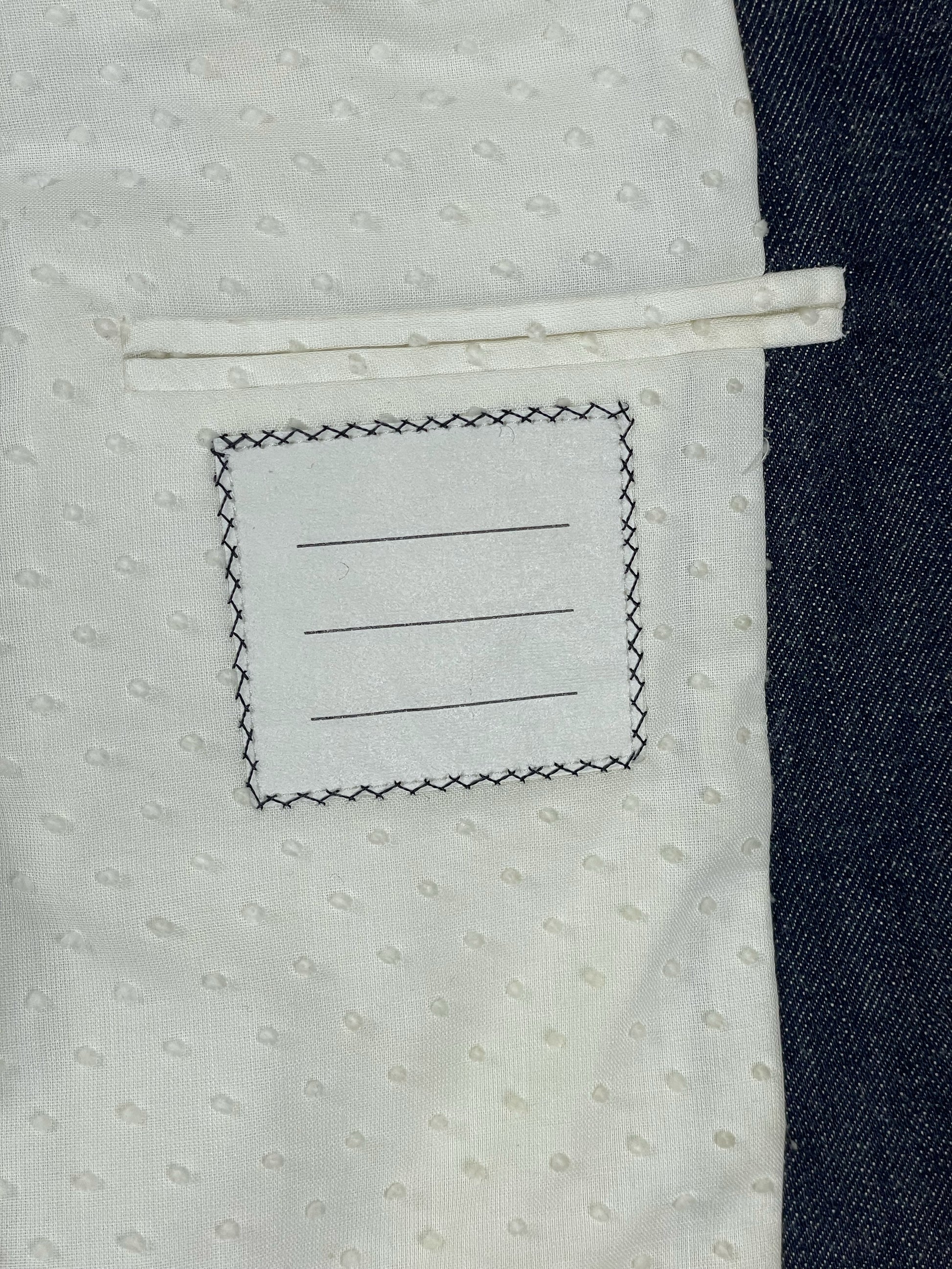 Thom Browne New York interior spec label on indigo Japanese denim jacket