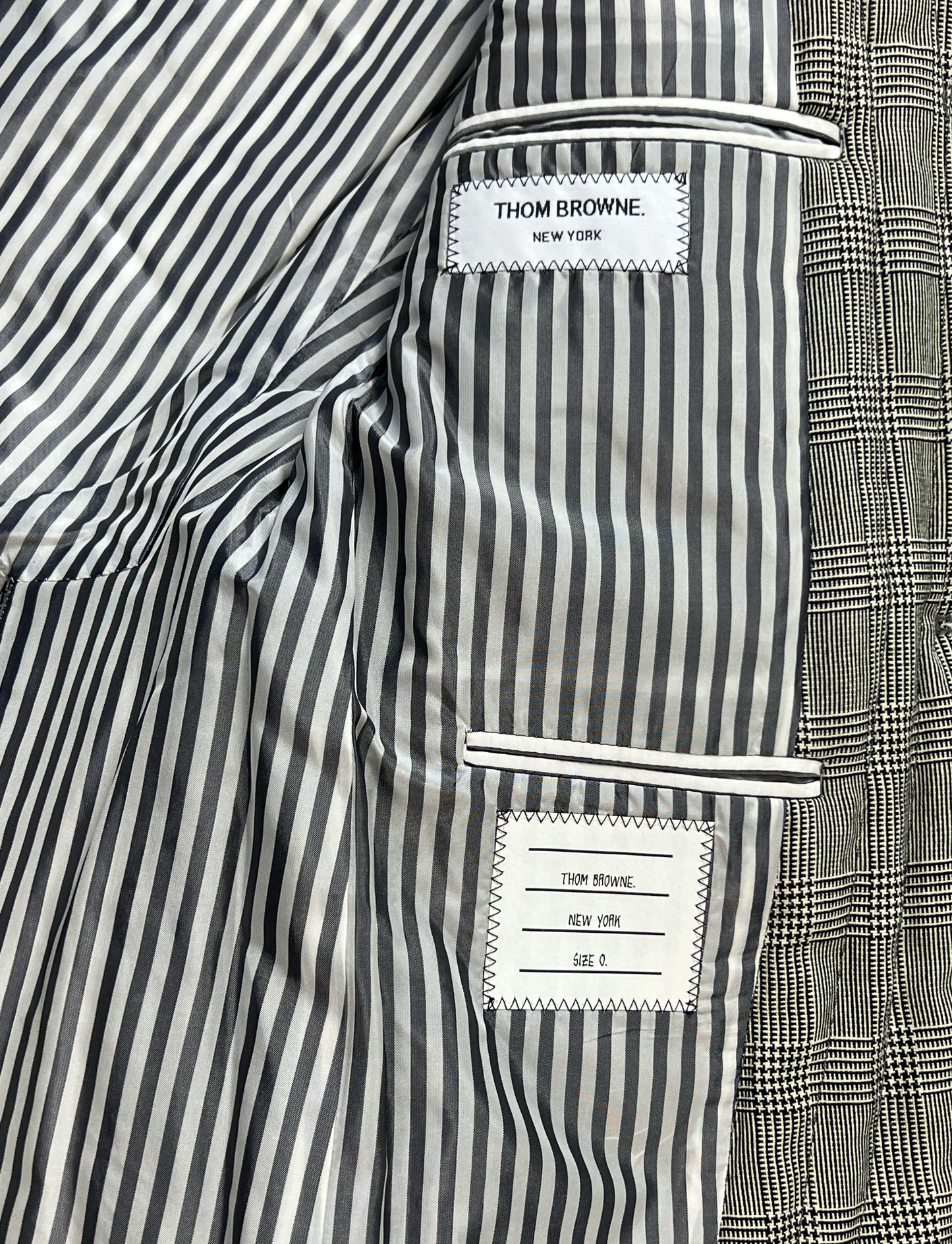 Signature black and white striped lining inside Thom Browne sport coat