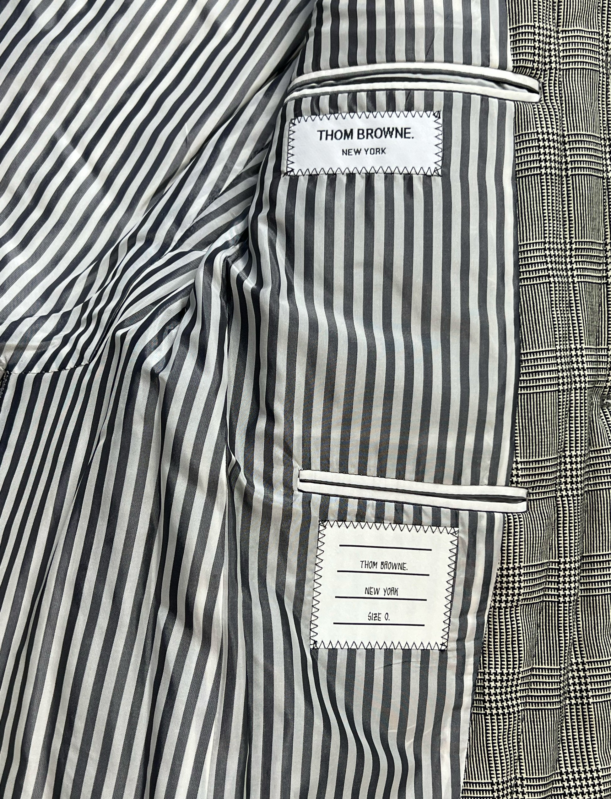 Signature black and white striped lining inside Thom Browne sport coat