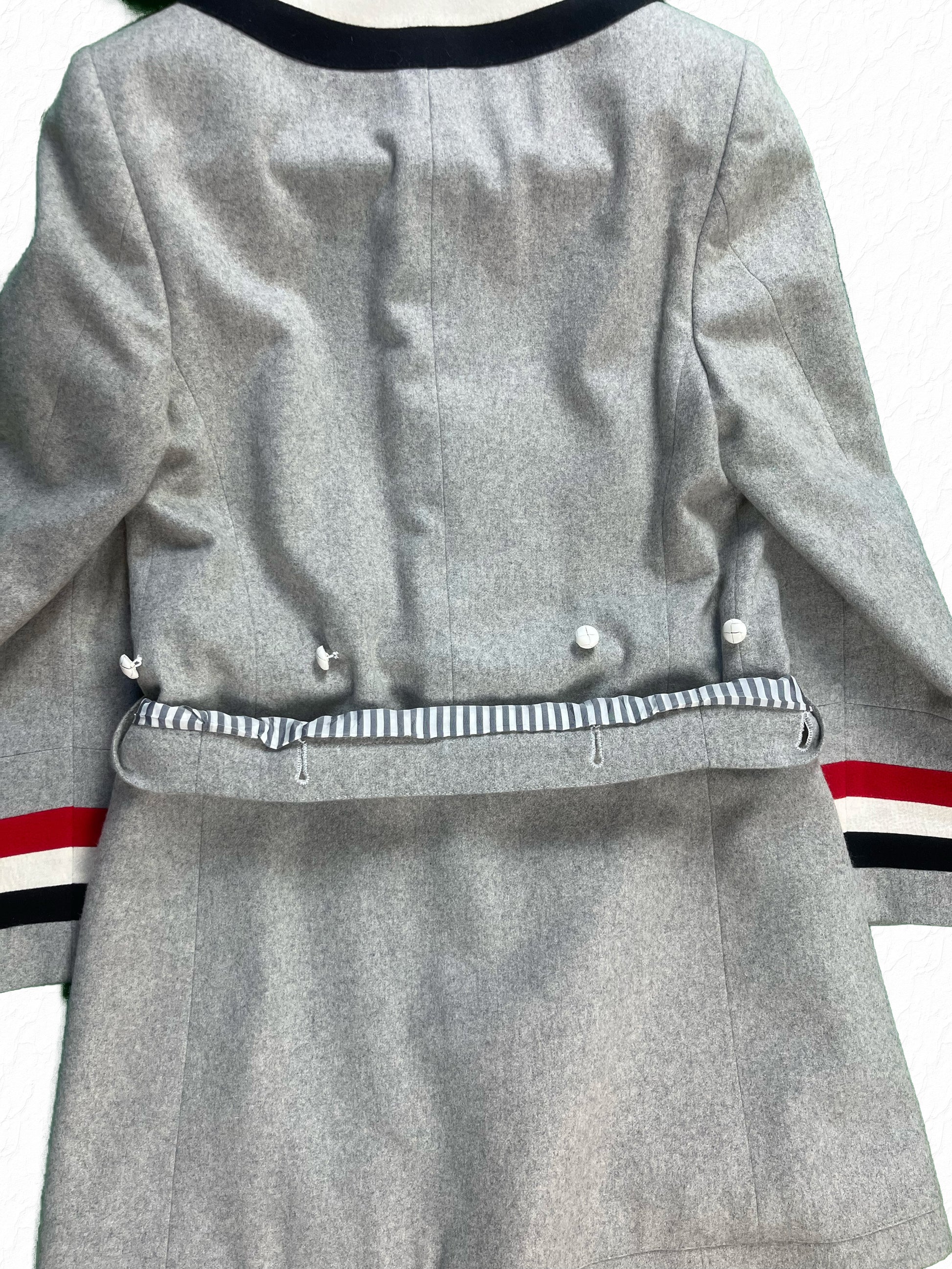 Grosgrain striped cuff trim on Thom Browne grey cashmere Priest Coat