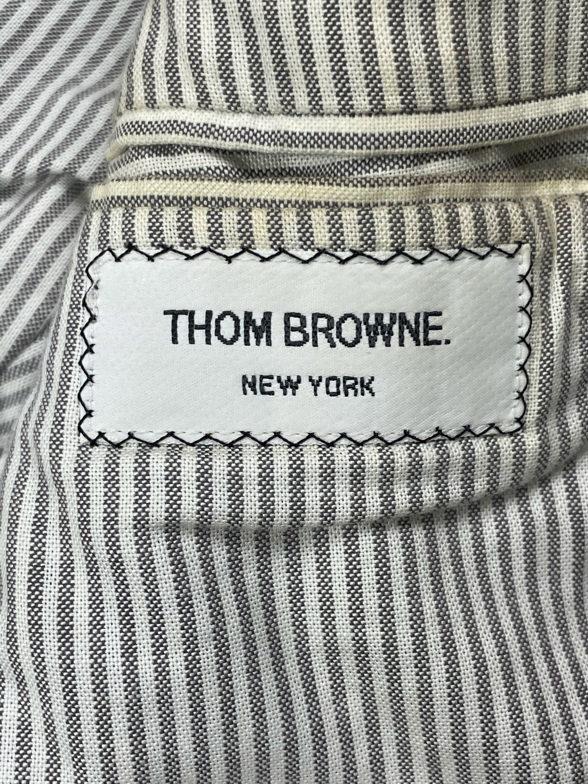 Thom Browne New York woven brand label on striped cotton lining