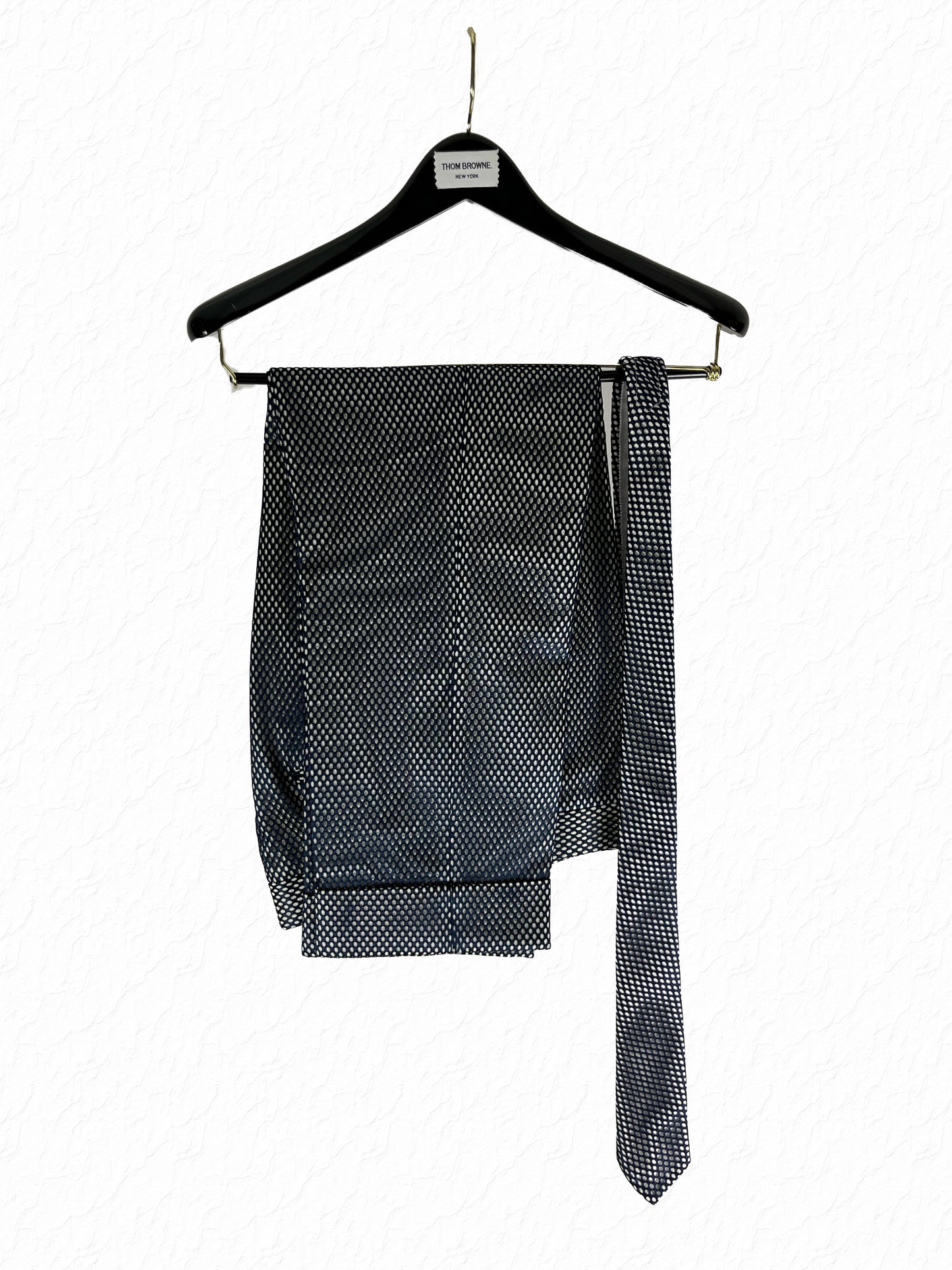 Marcella suit trousers by Thom Browne in navy mesh over white cotton