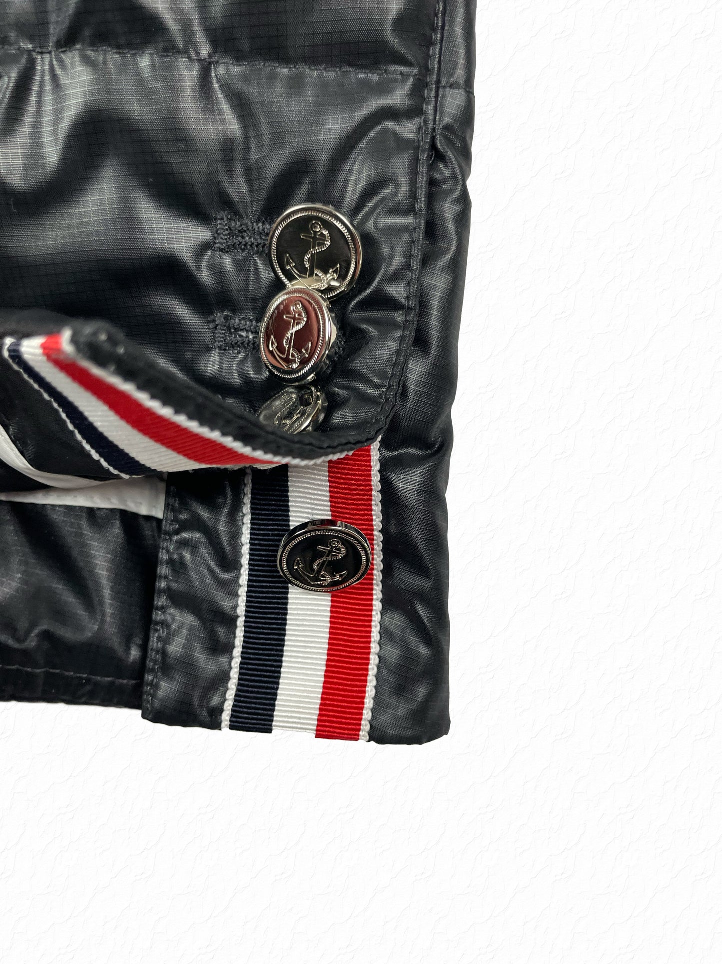Anchor engraved silver buttons on Thom Browne RWB grosgrain cuff tab