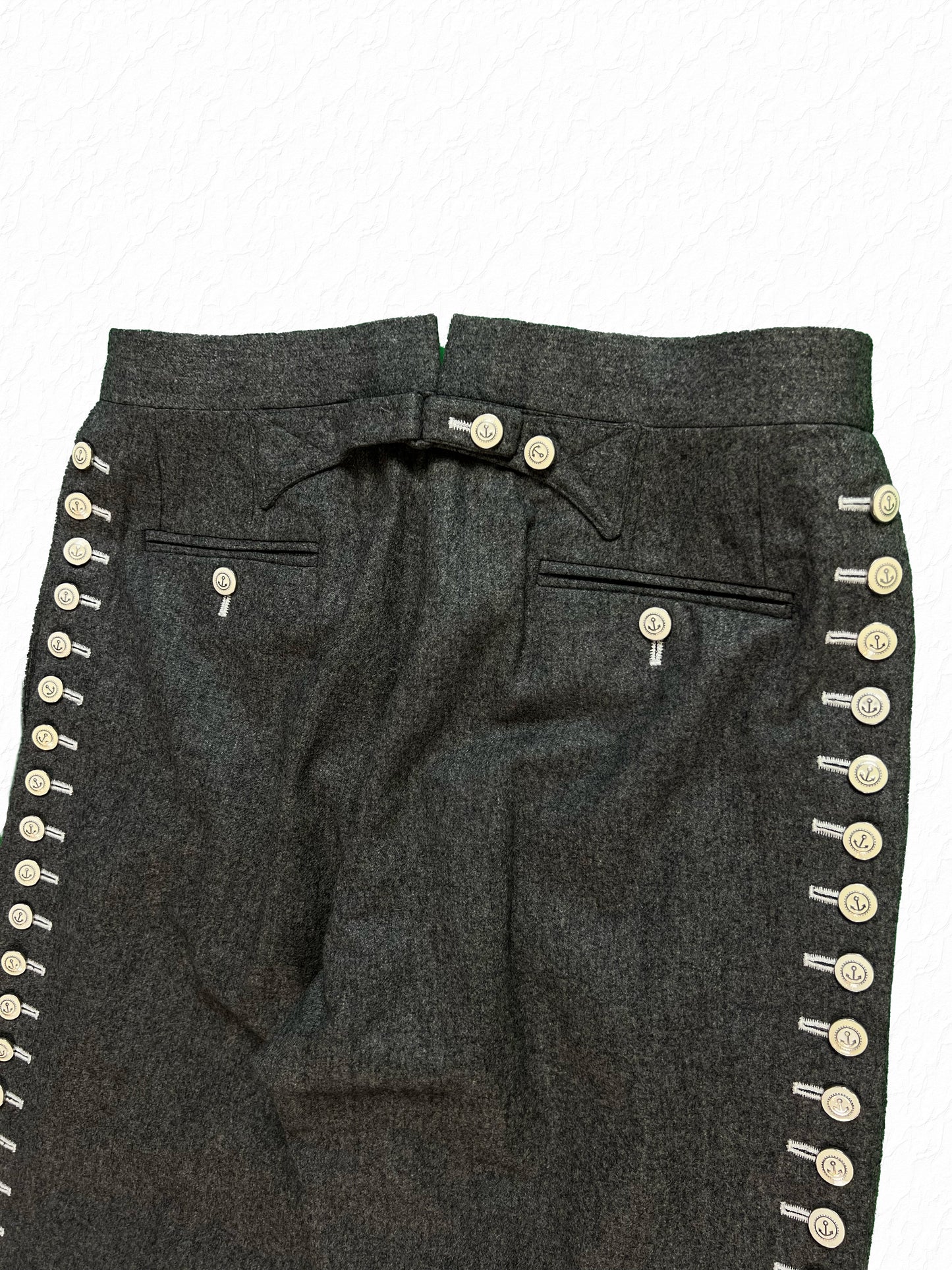 Buttoned waist tabs on Thom Browne archival flannel trousers