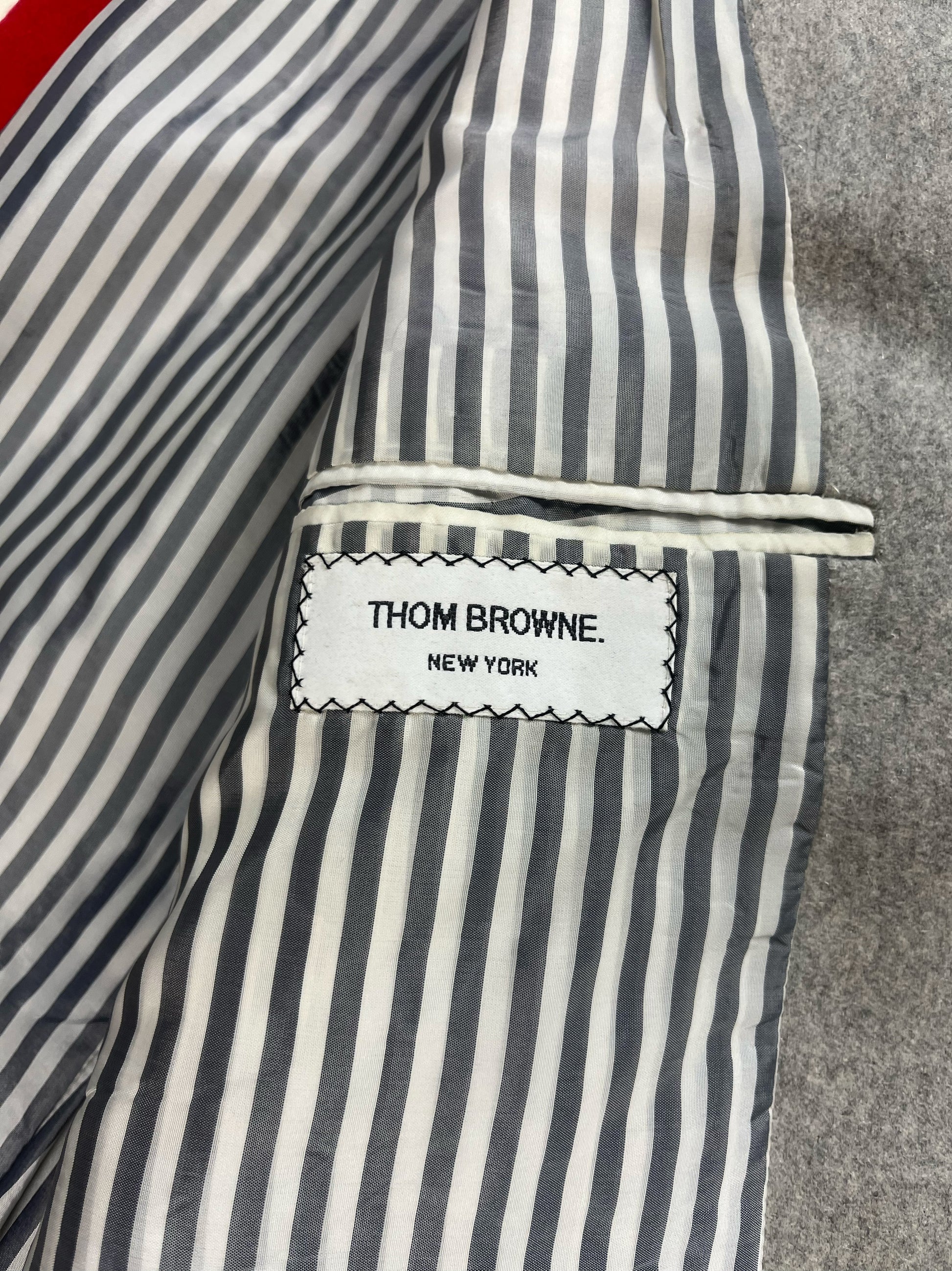 Thom Browne New York woven brand label on grey cashmere Priest Coat