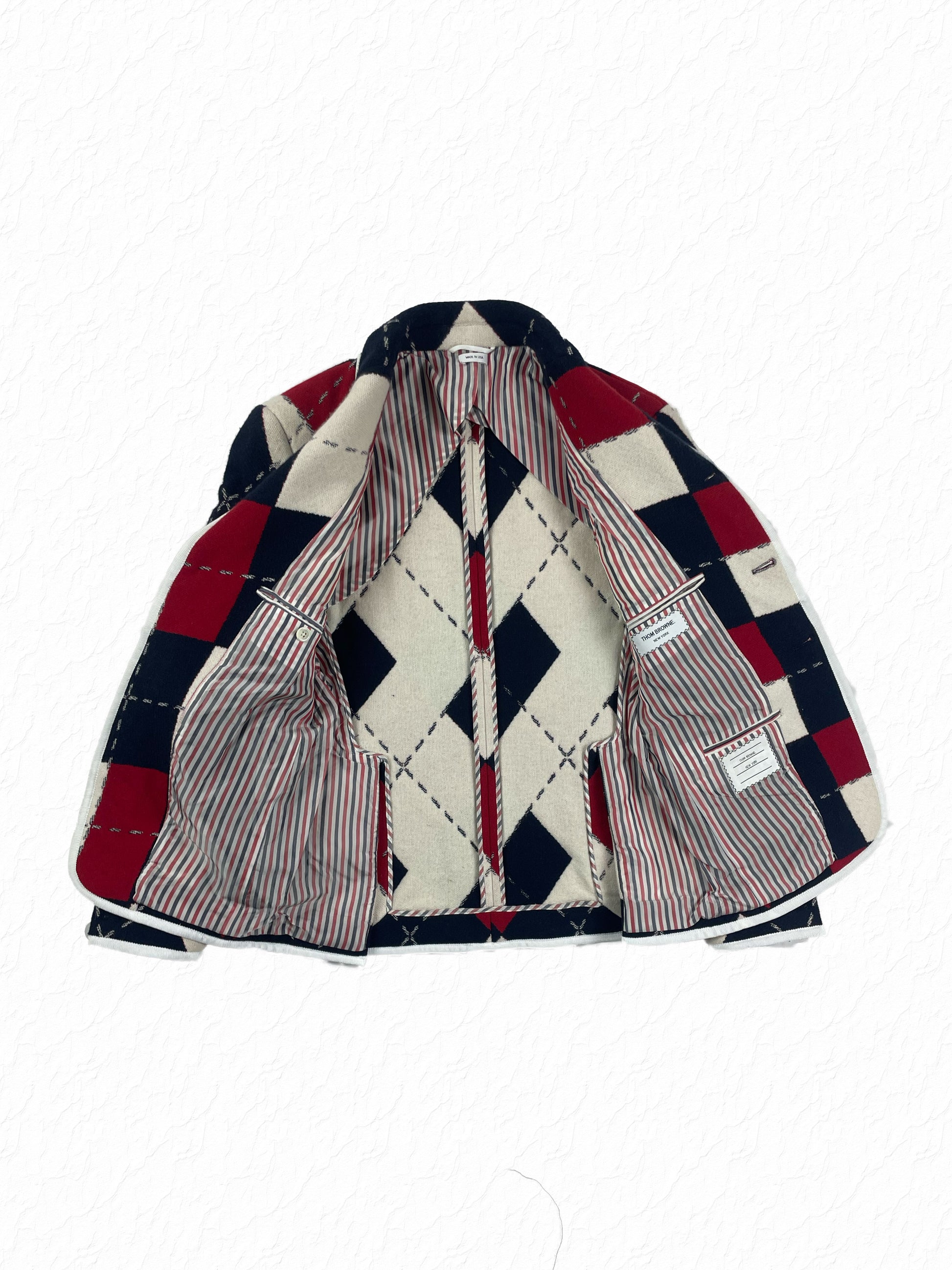Red, white, and blue argyle pattern across Thom Browne sport coat