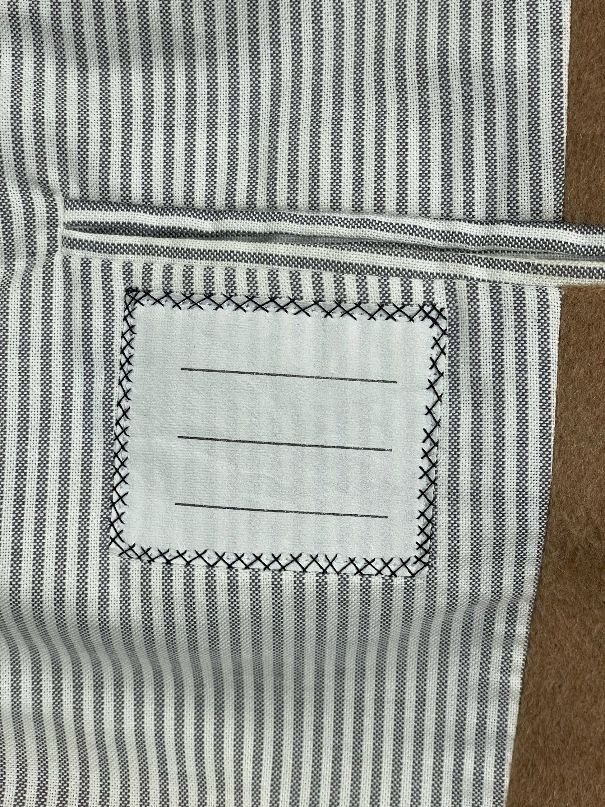 Striped cotton lining inside Thom Browne camel hair coat