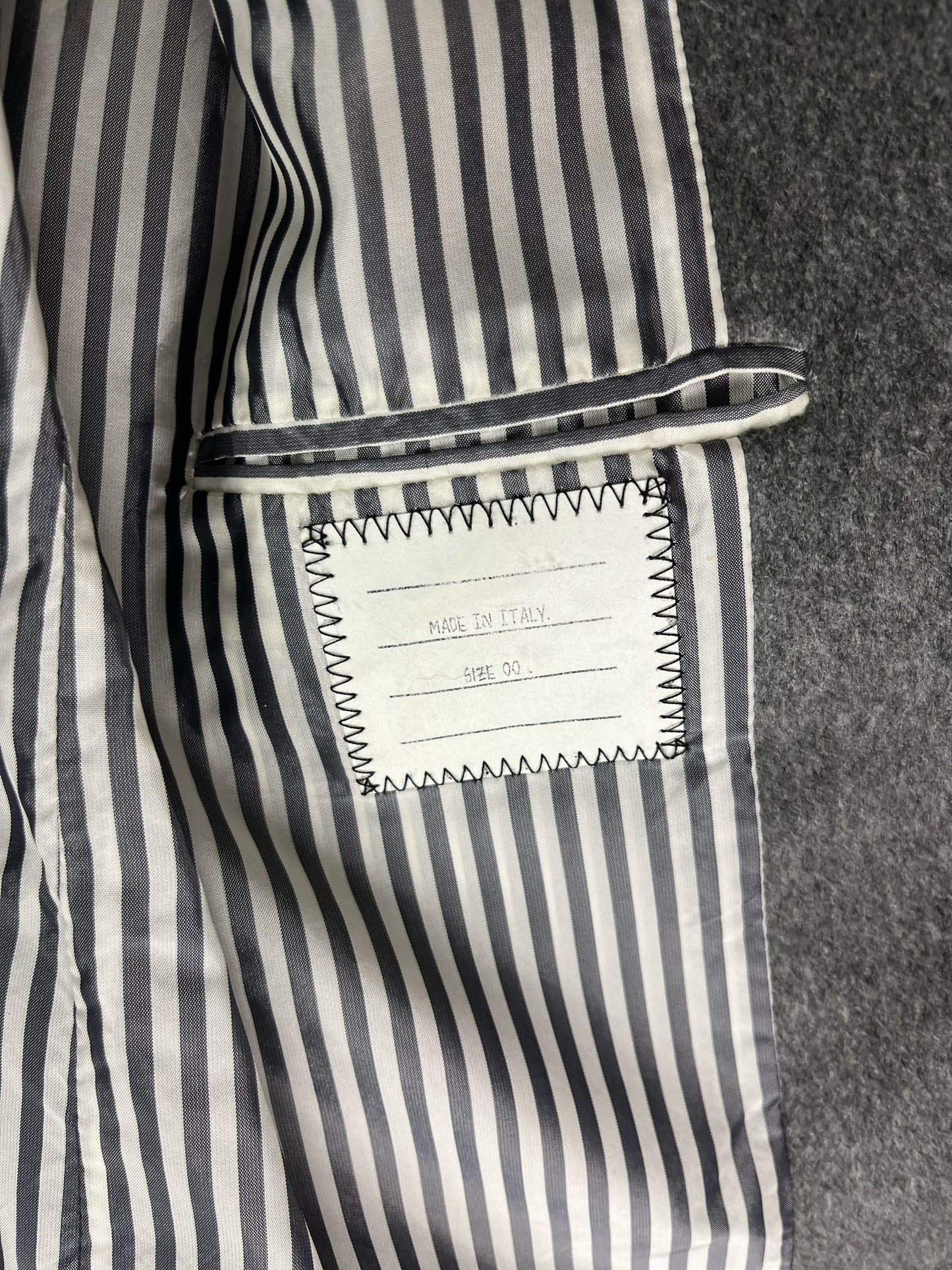 Grey striped internal lining on archival Thom Browne wool coat
