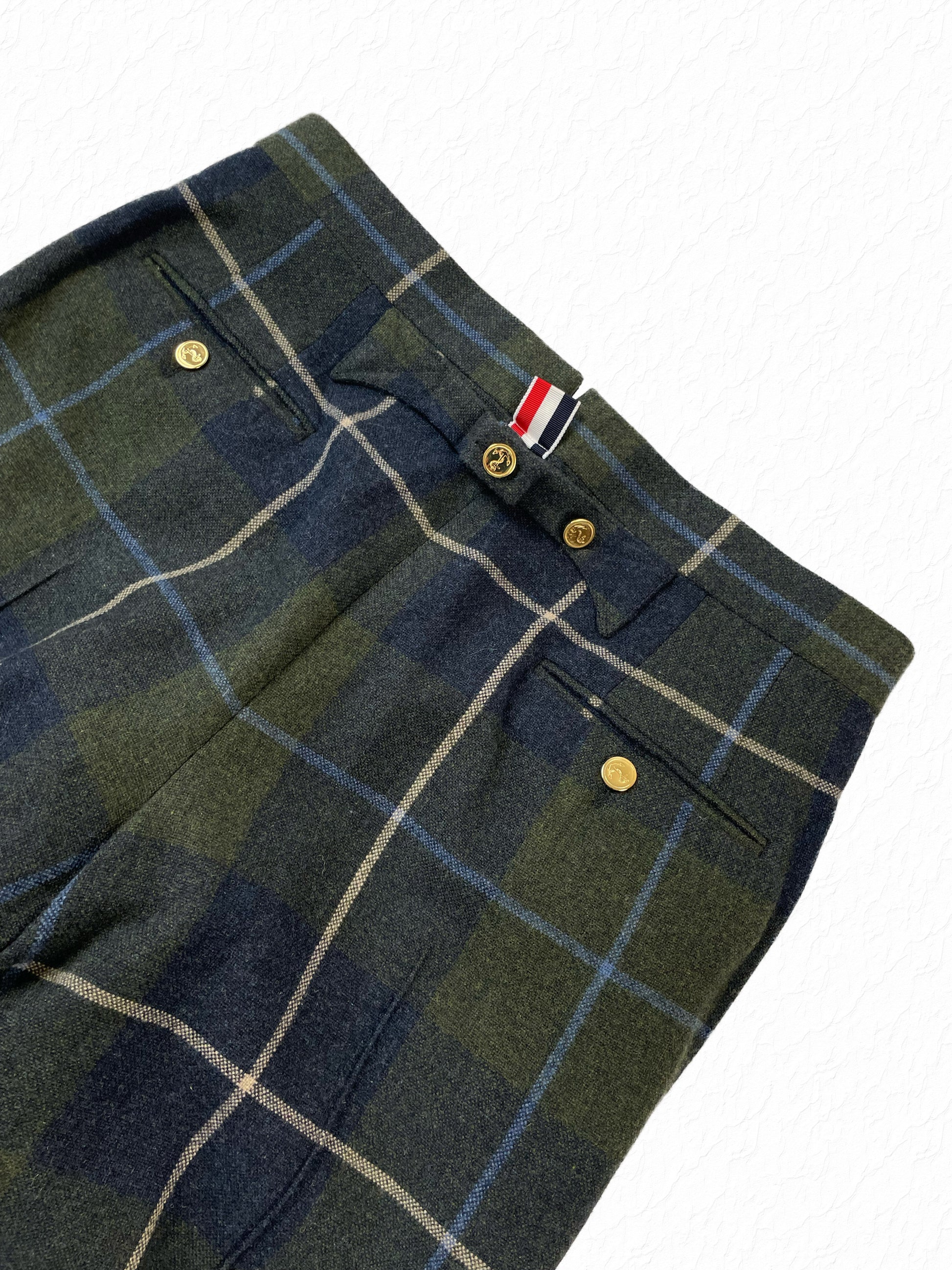 Signature red white blue grosgrain tab on Thom Browne tartan trousers