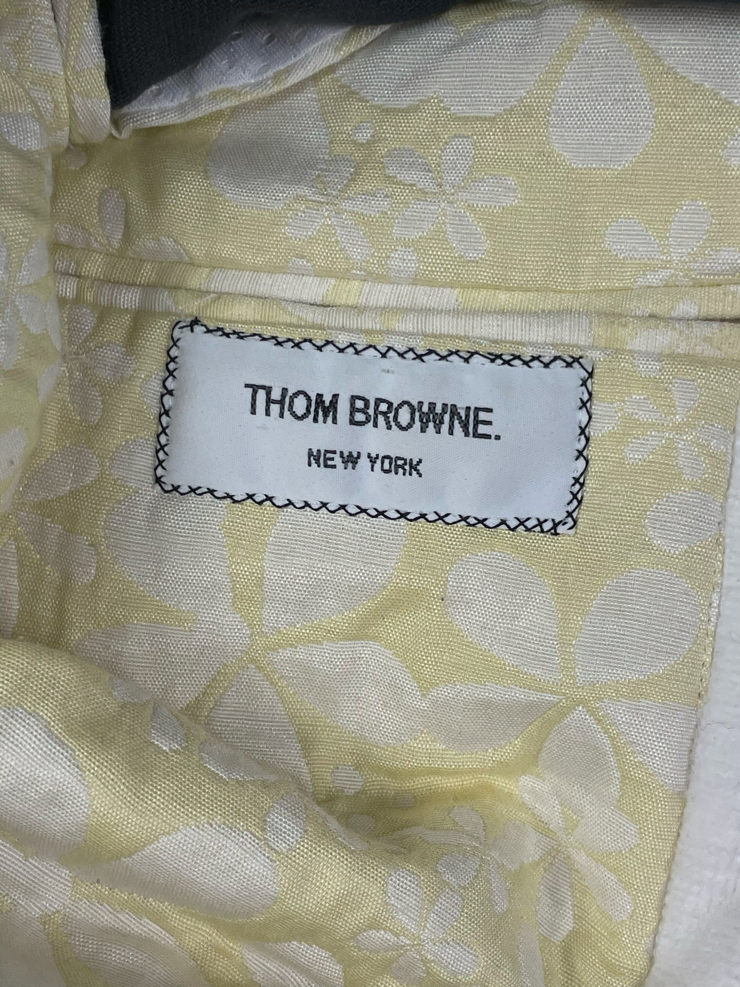 Thom Browne New York woven brand label on pastel yellow floral lining
