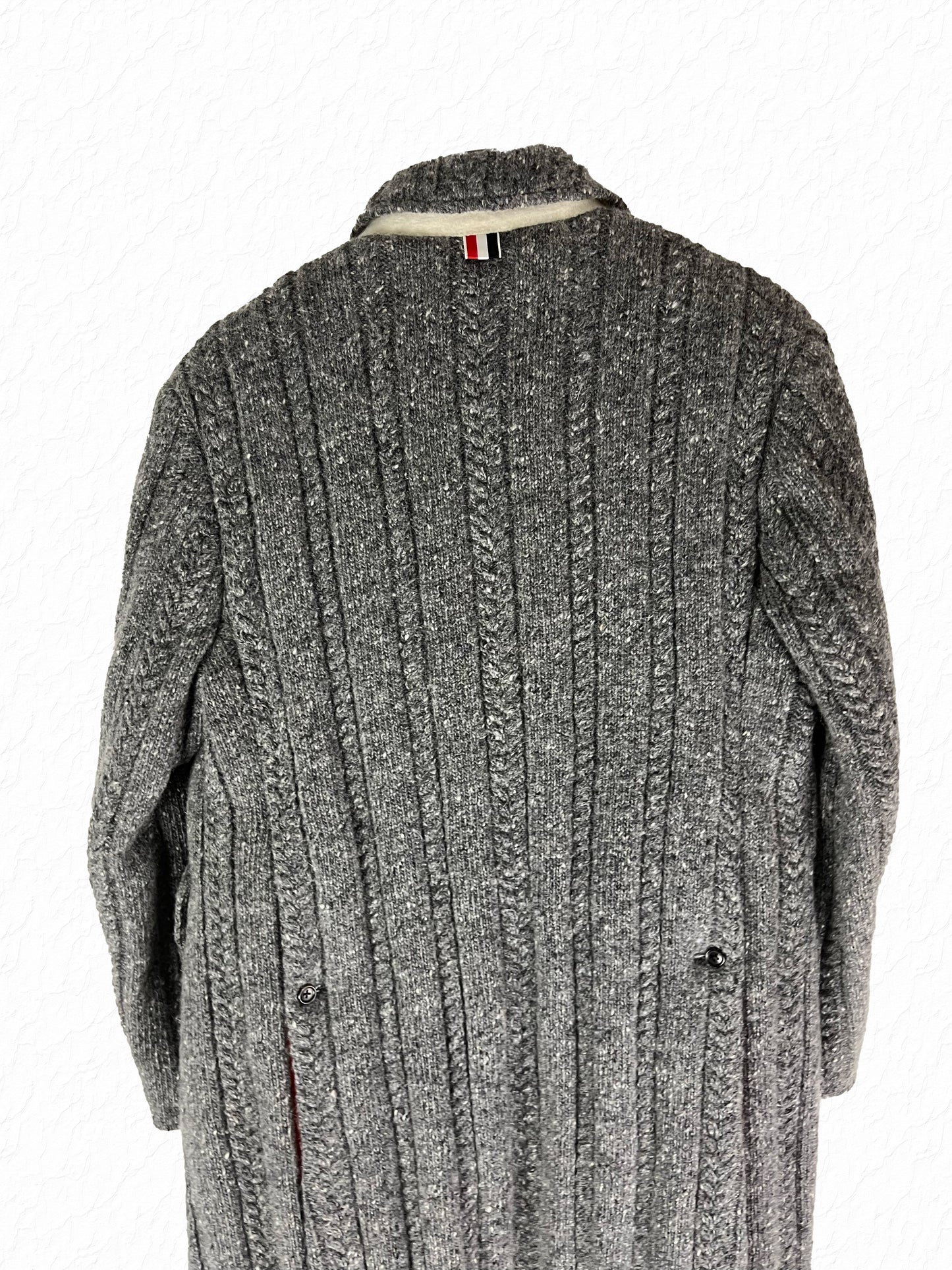 Cable knit Thom Browne overcoat with tonal horn buttons and RWB grosgrain tab